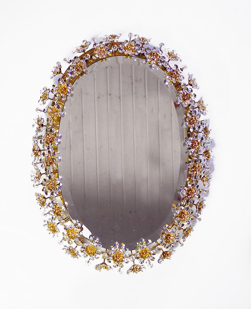 Eleganter ovaler, beleuchteter Spiegel mit facettierten Kristallen in Form von Blütenblättern und Blumen auf einem vergoldeten Messingrahmen. Entworfen von Christoph Palme attr. Hergestellt von Palwa, Deutschland, 1960er Jahre. 

Entwurf: