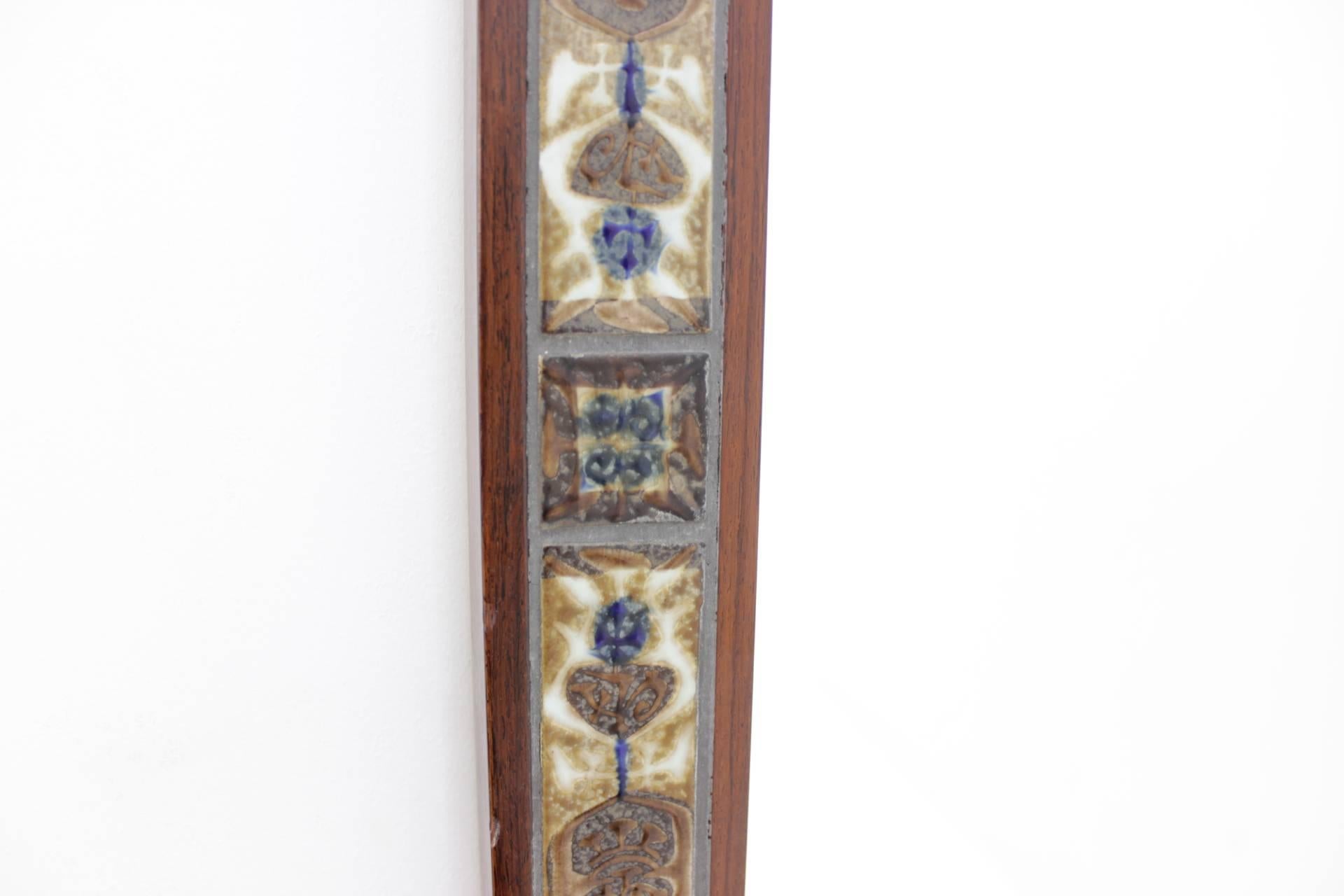 Palisander frame with tiles decoration. This item is in very good original condition with minor signs of wear.