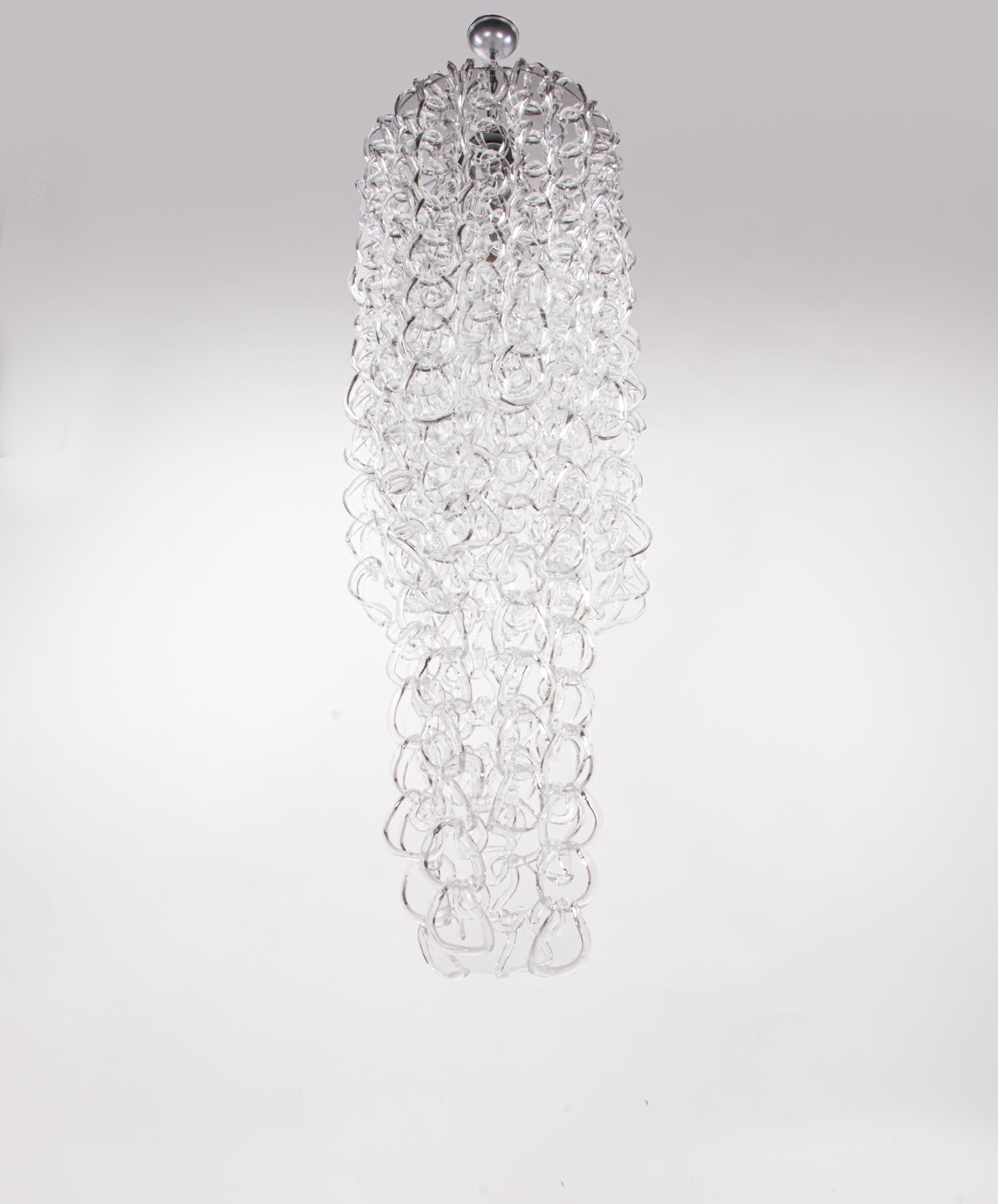 Imposing huge Giogali chandelier with numerous interlaced clear-white Murano glasses on a silver frame with chrome plated parts. The elegant Murano glasses can be individually arranged, so that the chandelier can be adapted to different environments