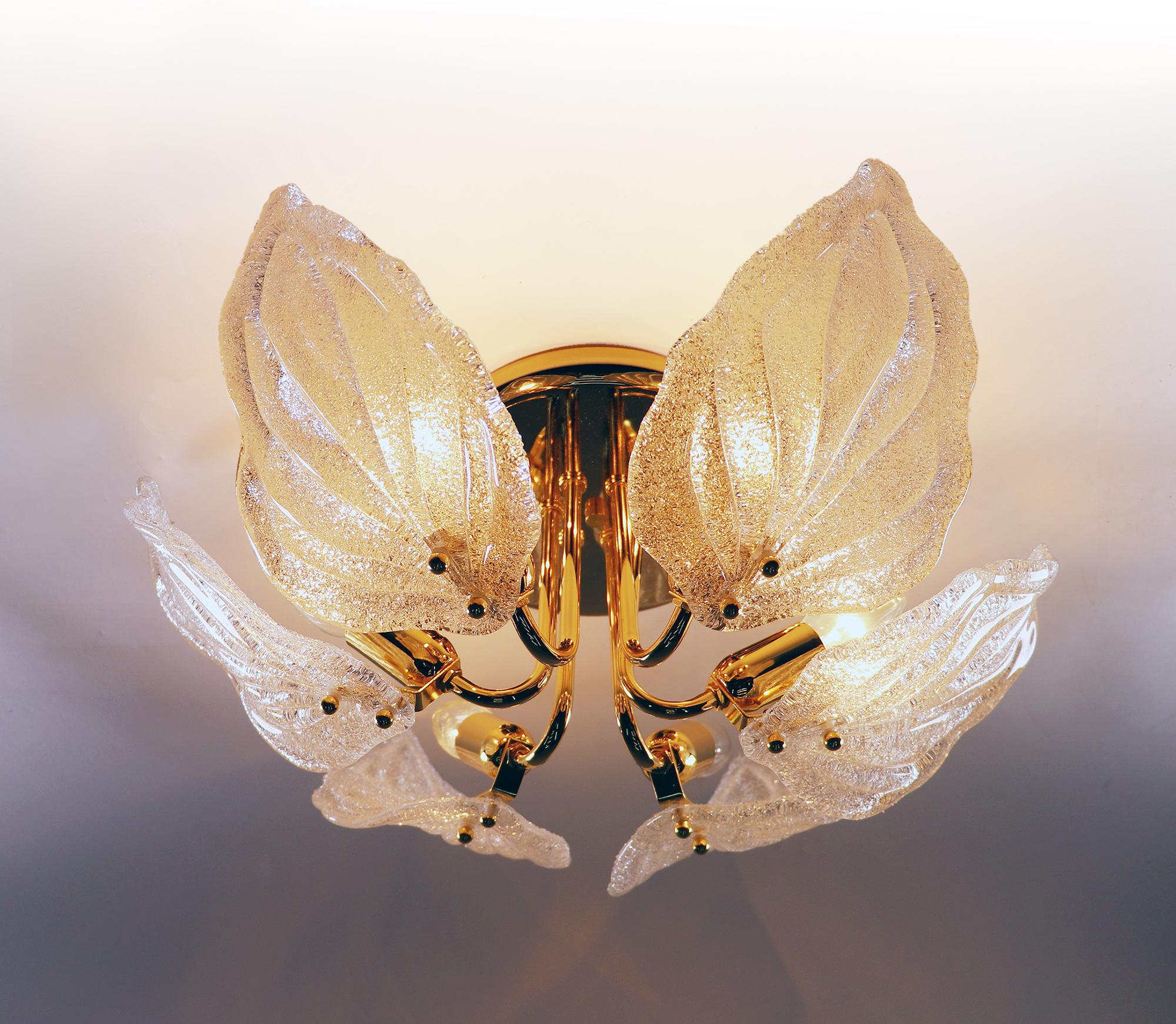 Elegant leaf flush mount chandelier with white textured Murano glass leafs on a gilded brass frame. Chandelier illuminates beautifully and offers a lot of light. Gem from the time. 
With this light you make a clear statement in your interior design.