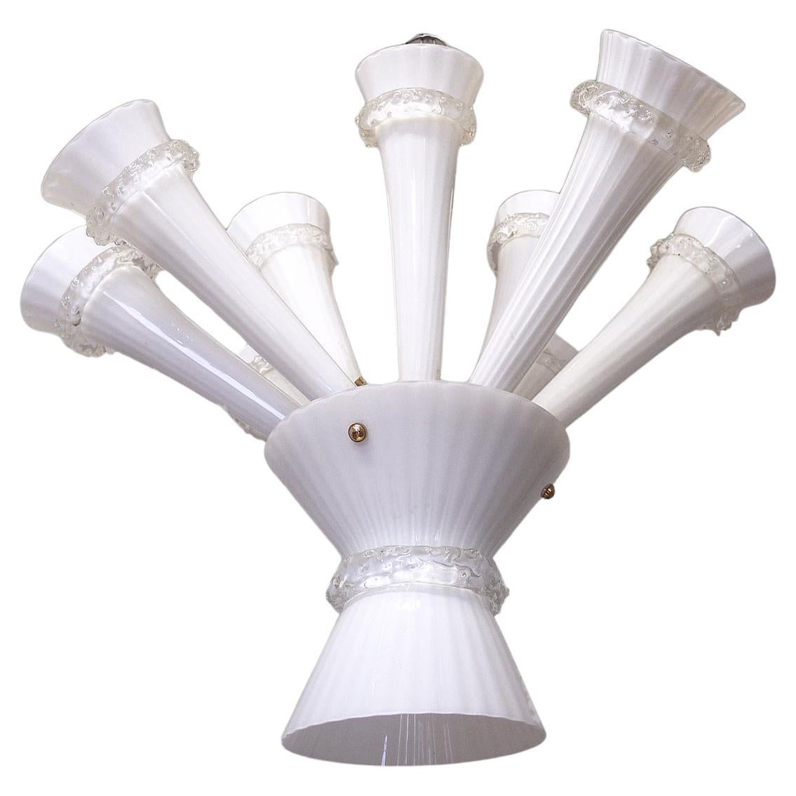 Elegant high quality handblown Venetian trumpet chandelier consisting of 12 opaline Murano glass arms on a gilt-brass frame. This elegant chandelier illuminates beautifully and offers a lot of light. Gem from the time. With this light you make a