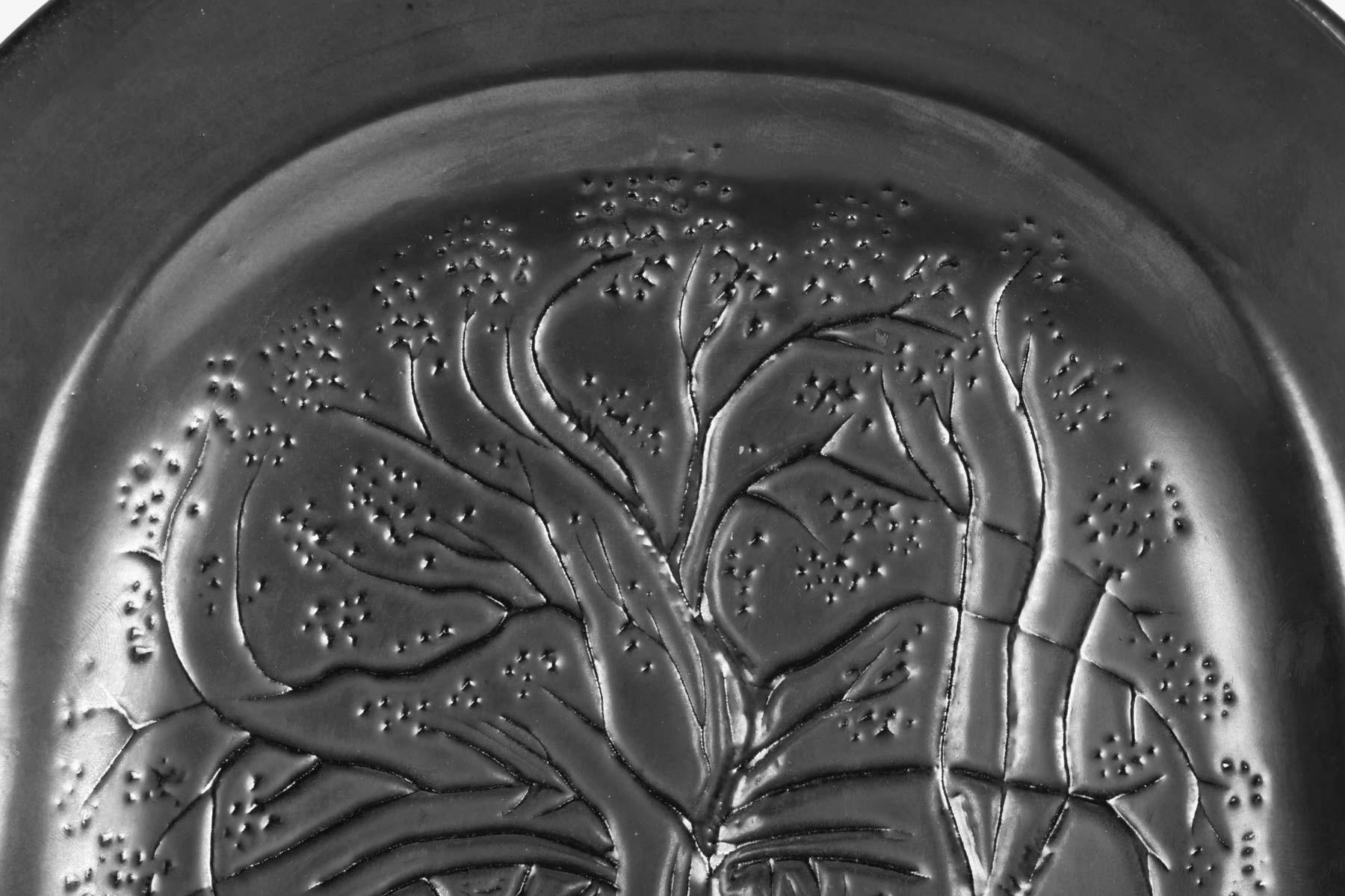 Poetical ceramic dish designed by Jean Marais in the 1960s.
The decor figures a hidden face among the branches of a tree. The drawing reveal the Jean Cocteau's influence. Black enameled ceramic.
Signature Jean Marais located on the dish border.
 