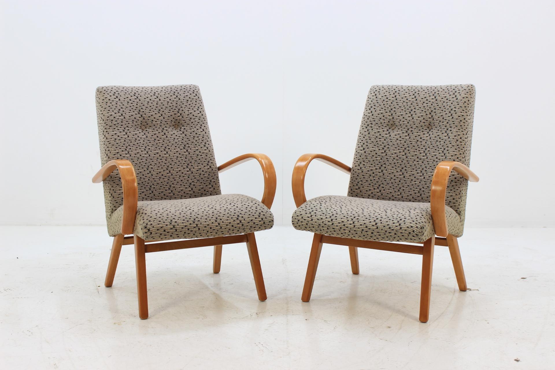 This chair was made in Czech Republic during 1960s by Jitona. Legs and bentwood armrests are made from beech wood. The original fabric upholstery of both chairs is in excellent condition.
