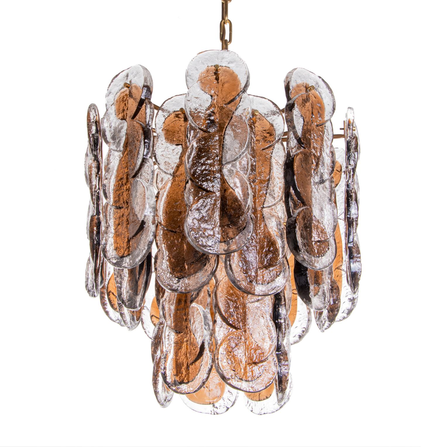 Elegant large citrus swirl chandelier with 24 amber and clear hand blown swirl patterned Murano glasses on a brass frame. 

The heavy handblown amber and clear Murano glasses have smoke-colored accents. Heavy execution. 

Manufactured by Carlo Nason