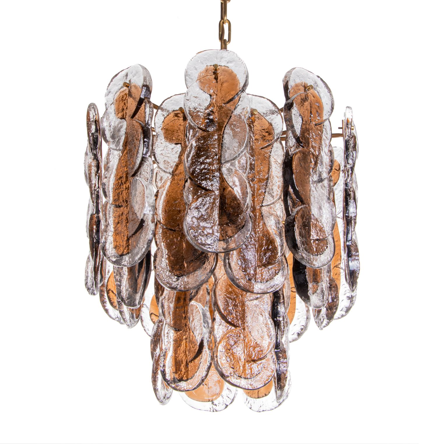 Elegant large citrus swirl chandelier with 24 amber and clear hand blown swirl patterned Murano glasses on a brass frame. The heavy handblown amber and clear Murano glasses have smoke-colored accents. Heavy duty. Manufactured by Kalmar, Vienna in