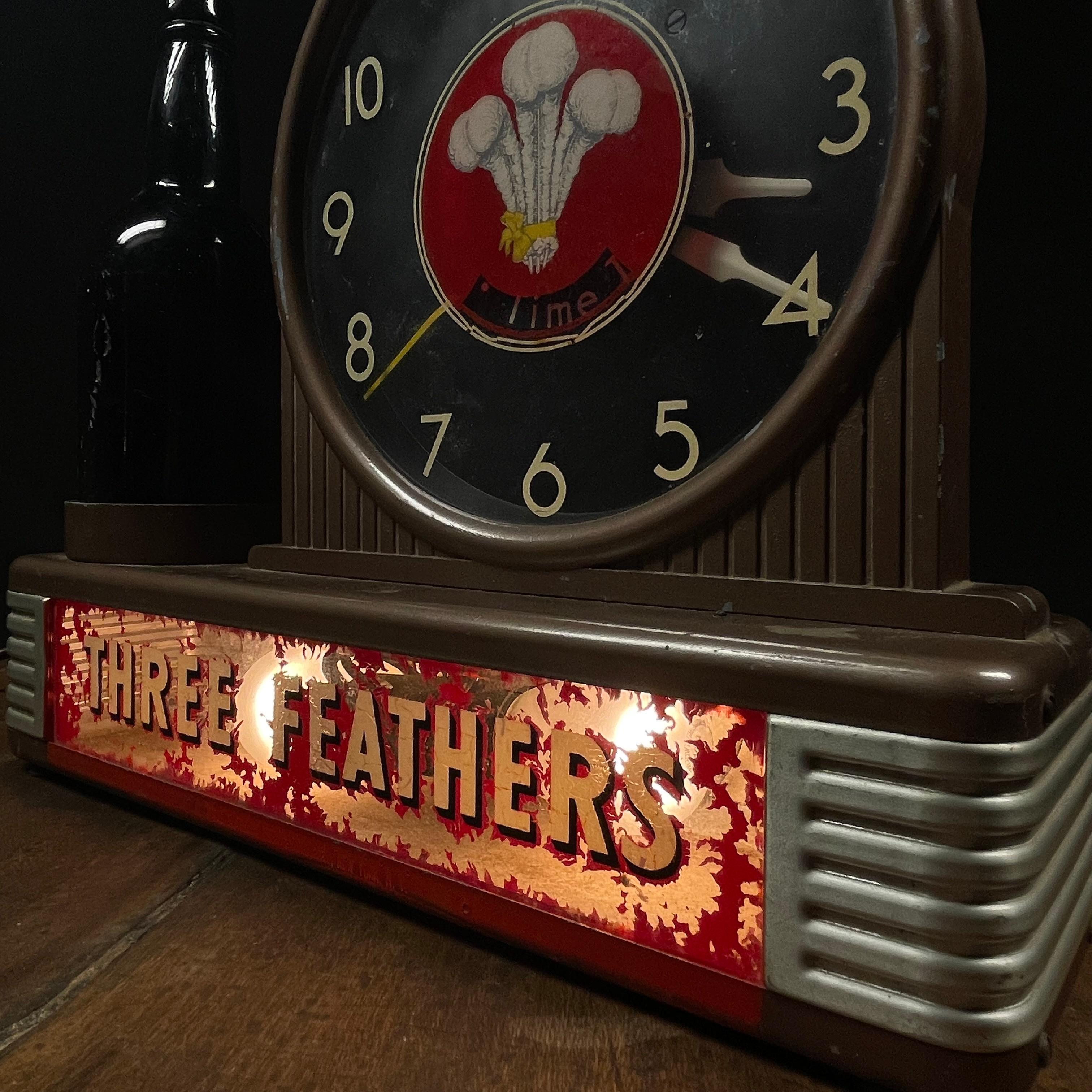 A great mcm advertising working whiskey sign light up box . A great piece of advertising in original condition .   
 Three Feathers Blended Whiskey is a vintage American blend, produced by Schenley in the 1950s and exported for the Italian market.