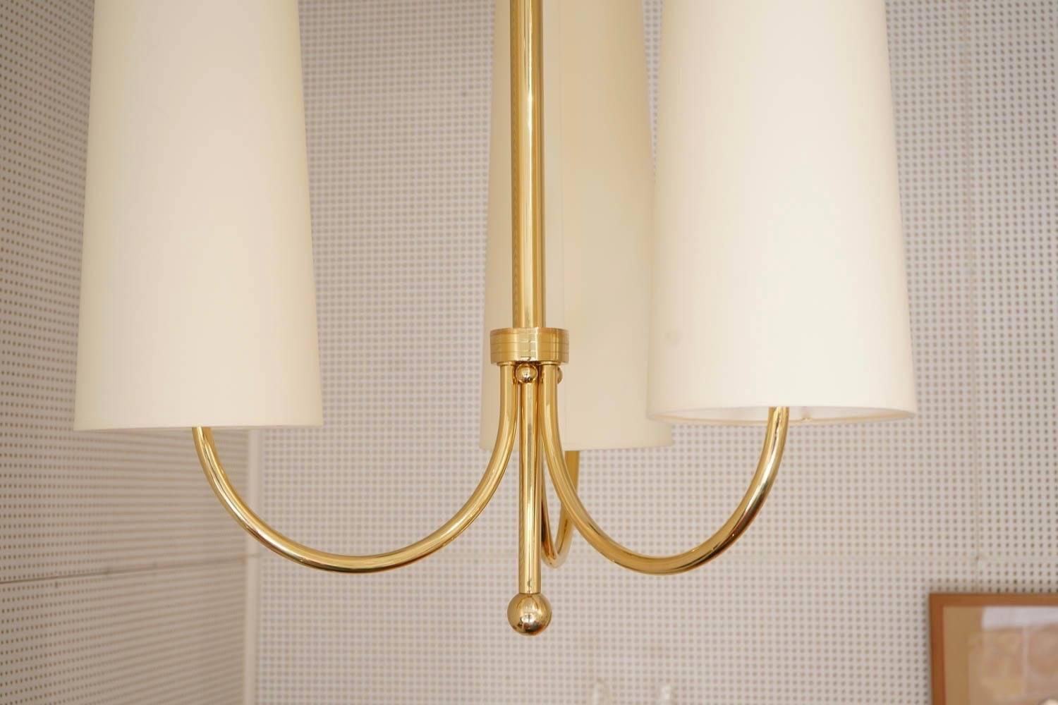 1960 Maison Honore Large Pair of Maison Honore Brass Sconces
Each sconce consists of brass central stem ended with a brass ball.
 Three lighted arms with off-white cotton lampshade.