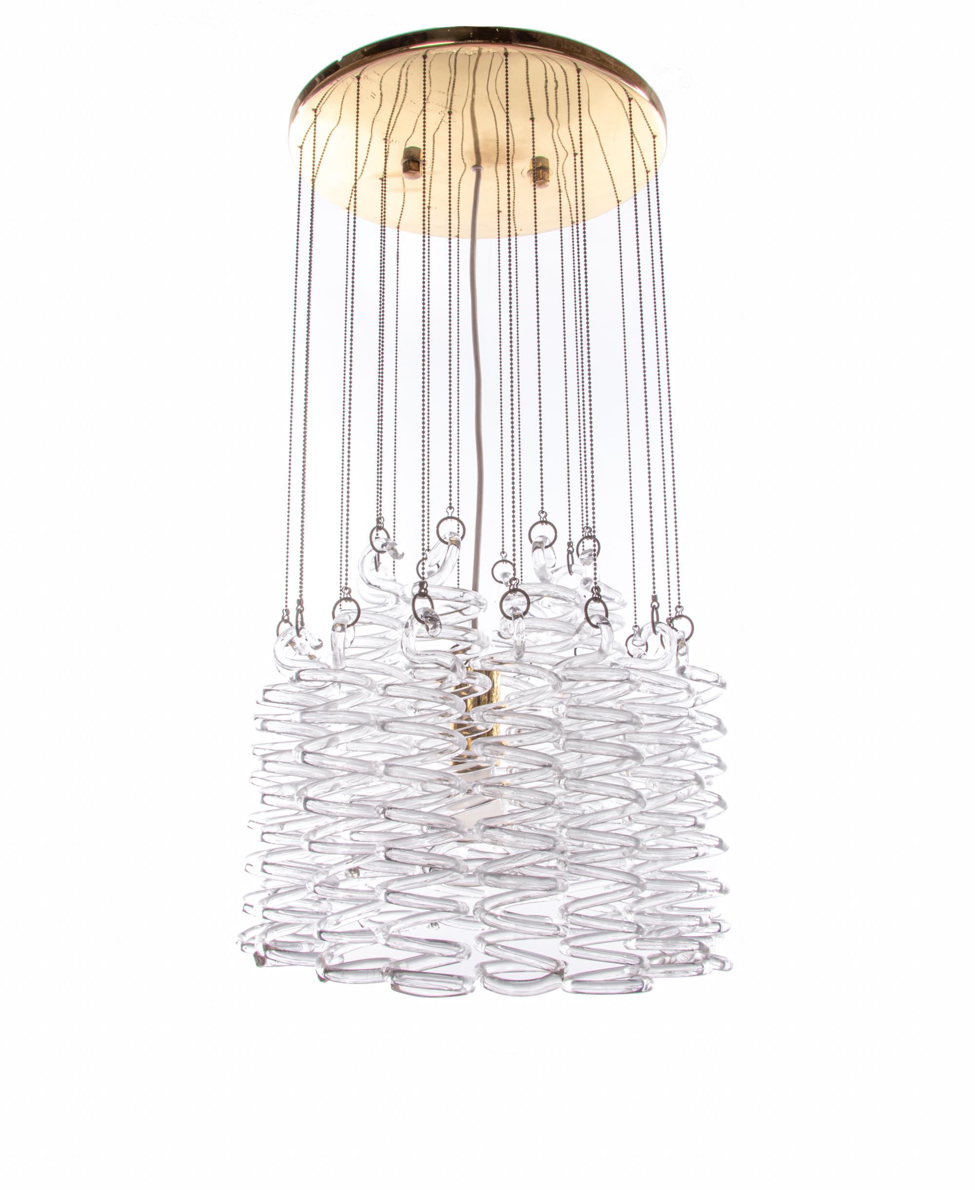 Elegant large Mid-Century Modern spiral cascade waterfall chandelier made of hand blown Murano glass spirals hanging down on chains attached to a brass ceiling plate. Chandelier illuminates beautifully. Gem from the time. With this light you make a