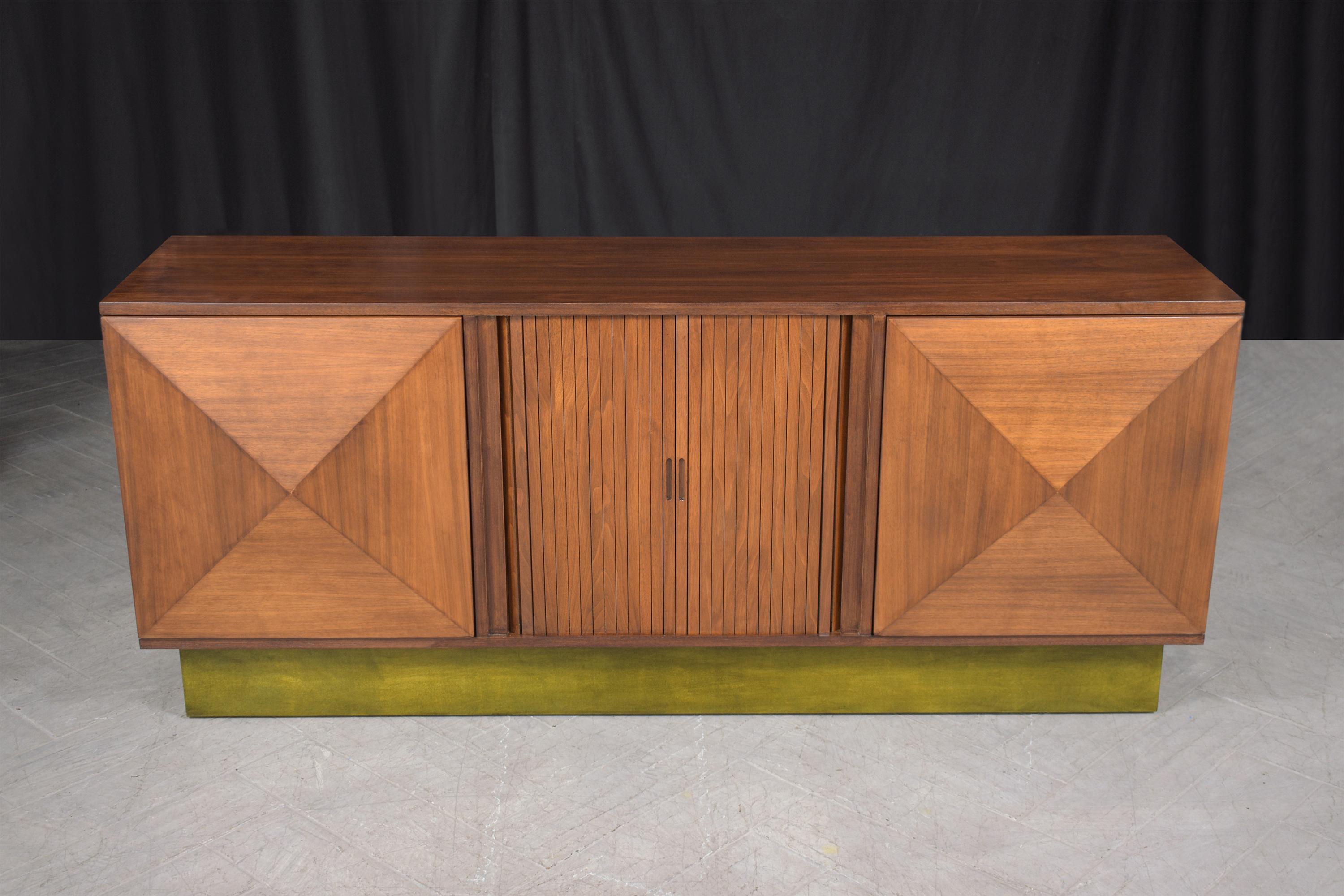 An extraordinary vintage 1960s lacquered credenza is hand-crafted out of walnut wood and has been completely restored and refinished by our professional expert craftsman team in the house. This credenza is sleek and features a walnut stain color