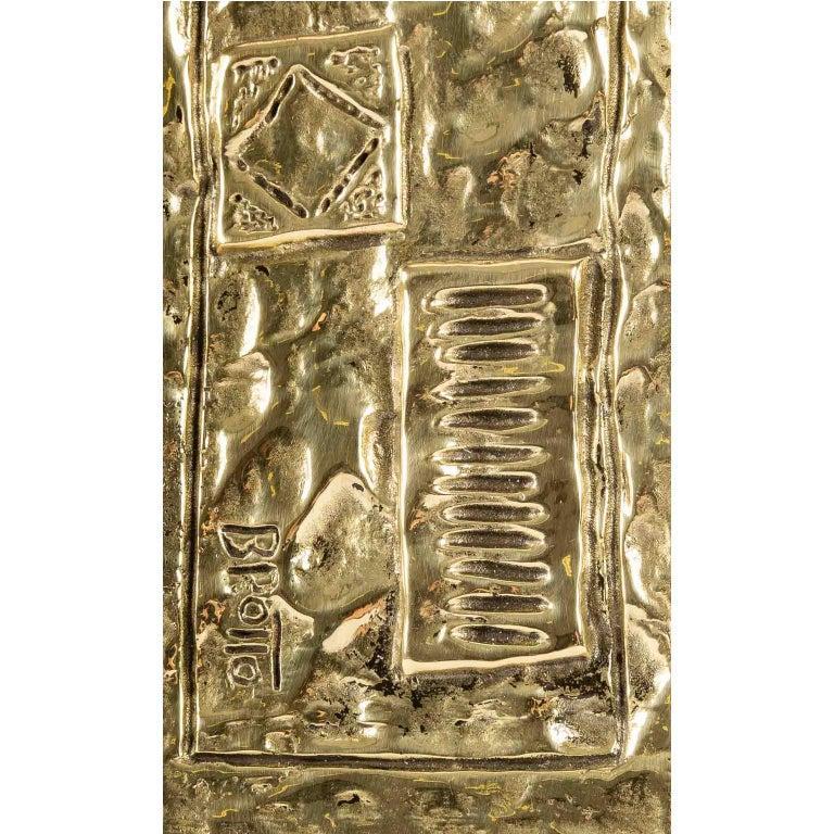 The mirror of rectangular form in height presents a border in gilded bronze decorated with geometrical cartridges in gilded bronze on all the height of the right part of the mirror.

It is signed on the facade in the lower part.