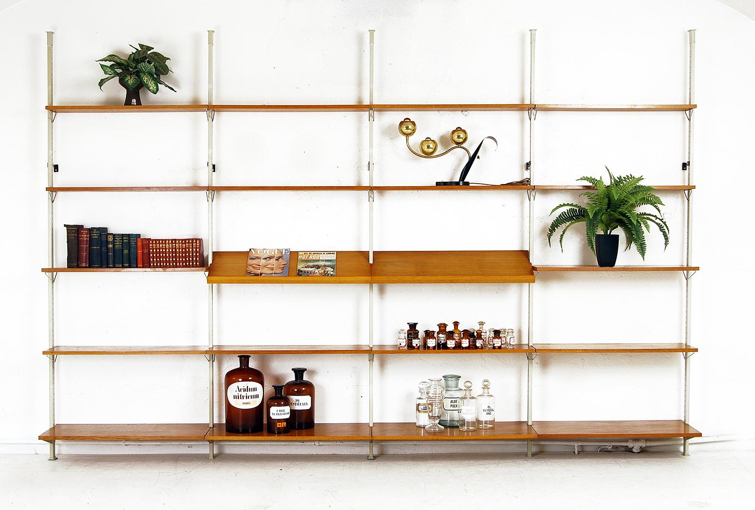 A very impressive and versatile Mid-Century Modern shelving system designed by Olof Pira in 1956 for String, Sweden, made of teak and steel. Each freestanding modular unit is designed as a ‘tension’ system where each upright is trapped between the