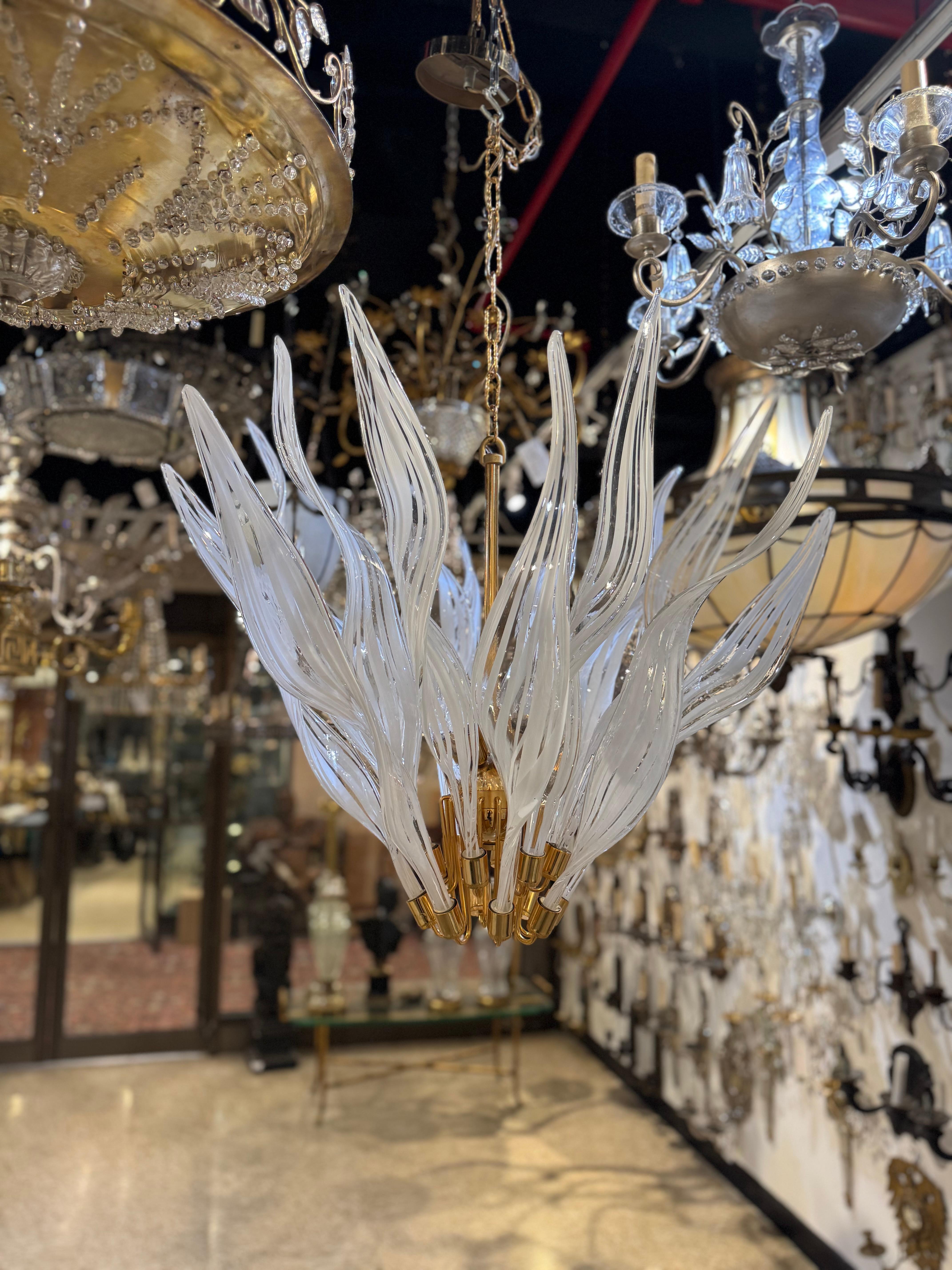 Circa 1960’s Murano glass chandelier with 16 white flames shaped blown glass design. Great condition with 8 interior lights