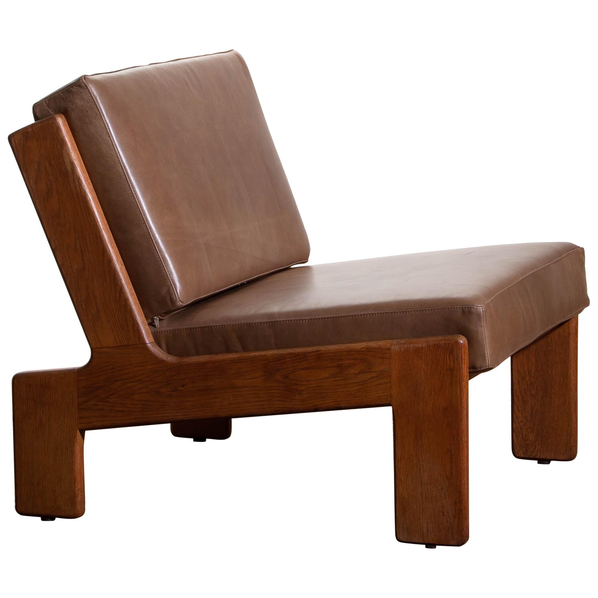 Extremely rare cubist lounge /easy chair designed by Esko Pajamies for Asko Finland in oak and leather.
The cushions are newly upholstered with leather. Also the bindings are replaced.
The overall condition is very good.

Note: We have two