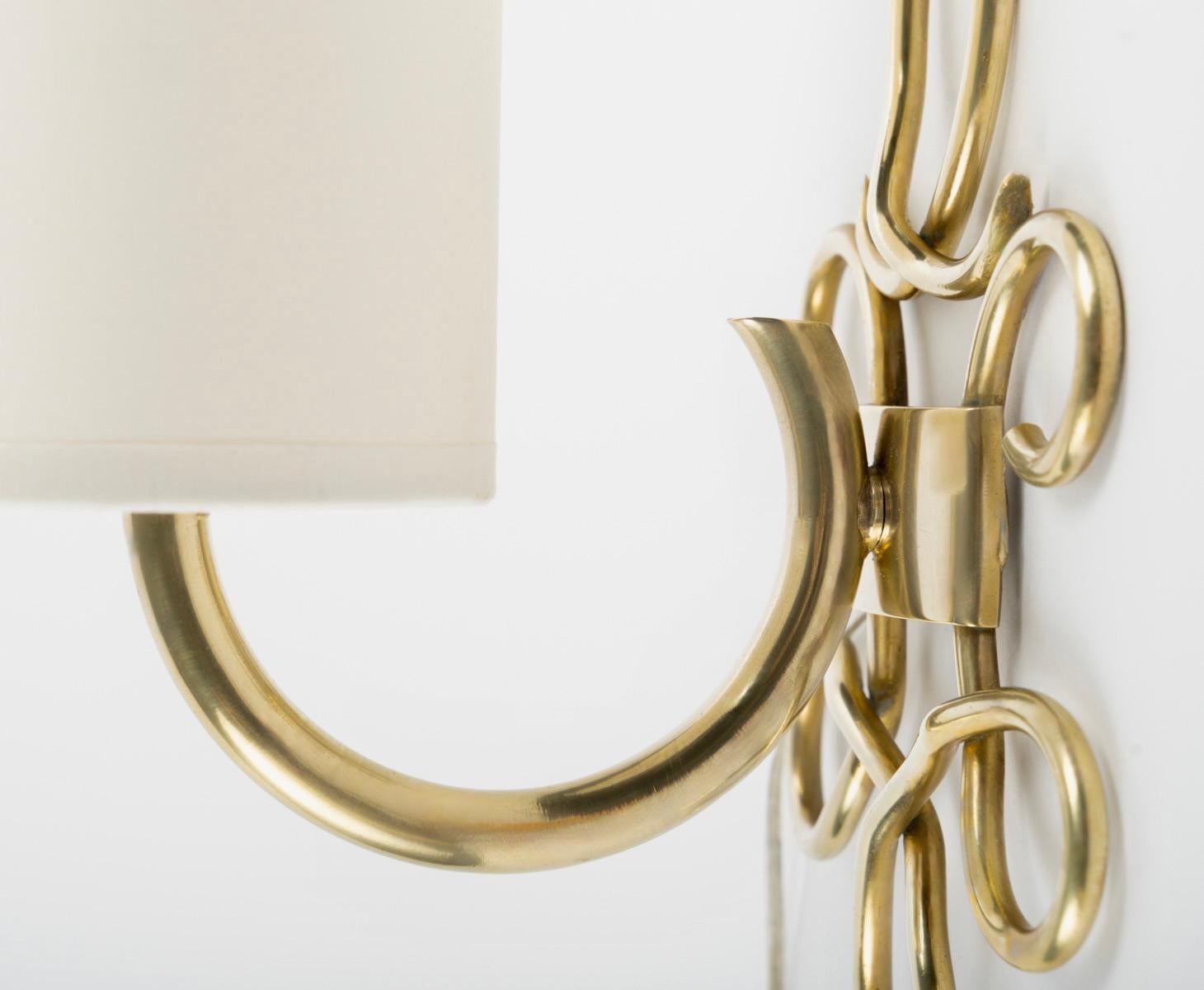 Mid-20th Century 1960 Pair of “Boucle” wall lights in gilded brass Maison Honoré For Sale