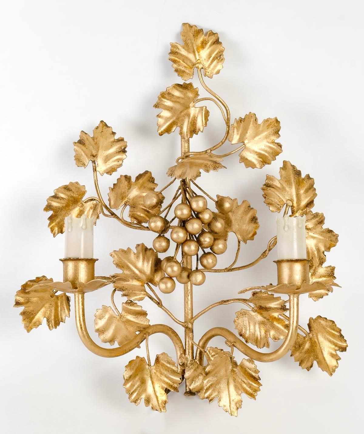 Pair of grapevine sconces by FlorArt.

Composed of a large grape leaf motif surrounding a cluster of grapes.
Two ascending arms of light on either side of the sconce are adorned with luminous candles, highlighted at the base by petal-decorated