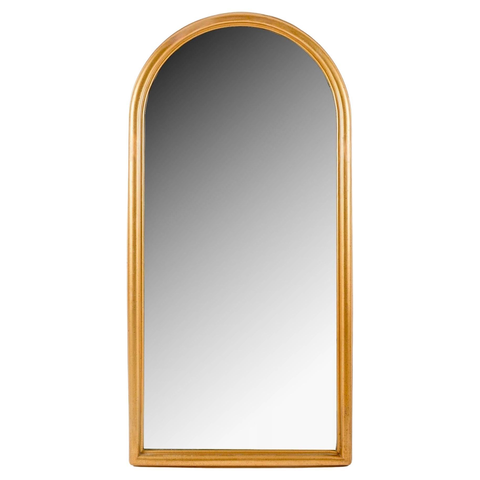 Pair of timeless gilded wood mirrors

Composed of a molded and gilded wooden frame, adorned at the top with a 
Romanesque-inspired ogive. 
In the center, a large mirror follows the shape of the frame. 
