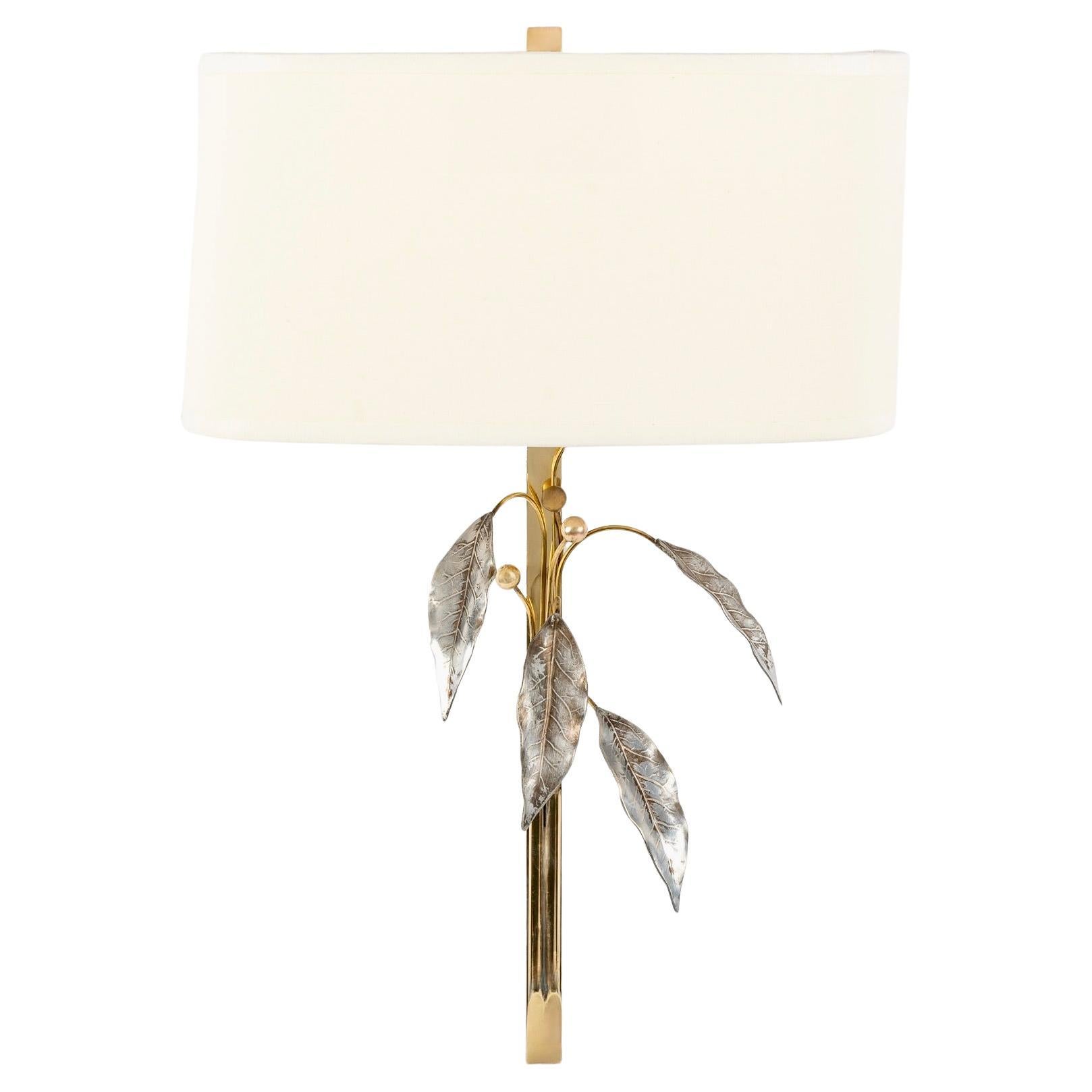 Composed of a gilded brass rod decorated and embellished with silver foliage and stylized flowers represented by gilded brass balls distributed on the front of the sconce.
Each sconce is dressed with a half shade of off-white cotton, custom made and