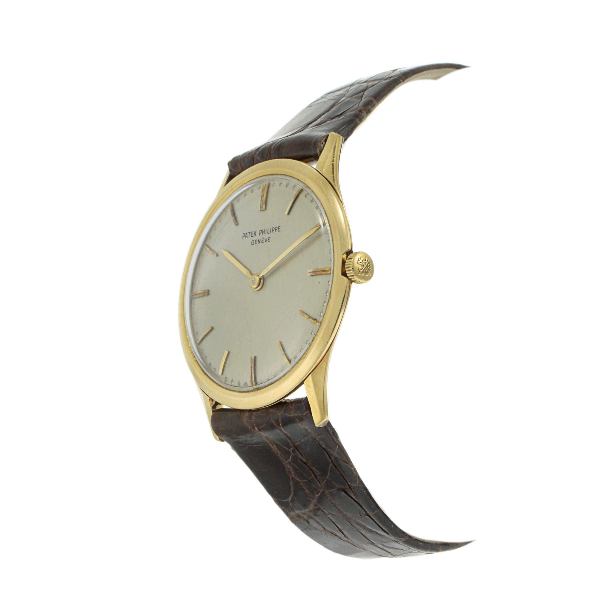 Elegant Patek Philippe wristwatch from 1960.

This refined timepiece features a manual movement and a 33mm watch face.

The dial is a sleek silver, adorned with baton indexes for a minimalist look.

Crafted in 18k yellow gold, the case exudes luxury