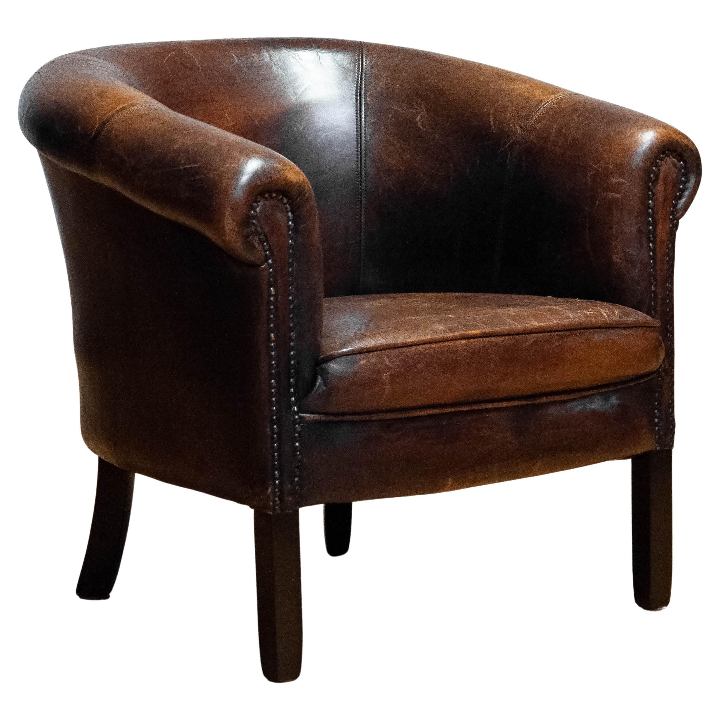 Characteristic and extremely decorative Dutch colonial arm chair upholstered with dark brown patinated tan sheepskin. Allover in good and comfortable condition and supports great.

Please note!
Because Shipping Costs highly fluctuate daily, we