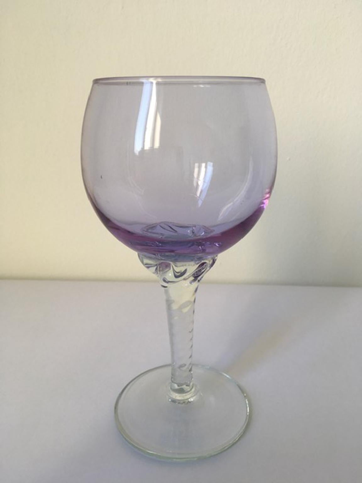 This is an elegant goblet hand made in Murano, Venice in 1960 in Murano blown glass. The piece is very charming and on it are visible the signs of the handwork.
The foot is in clear blown glass and the cup has a vibrant color, the purple