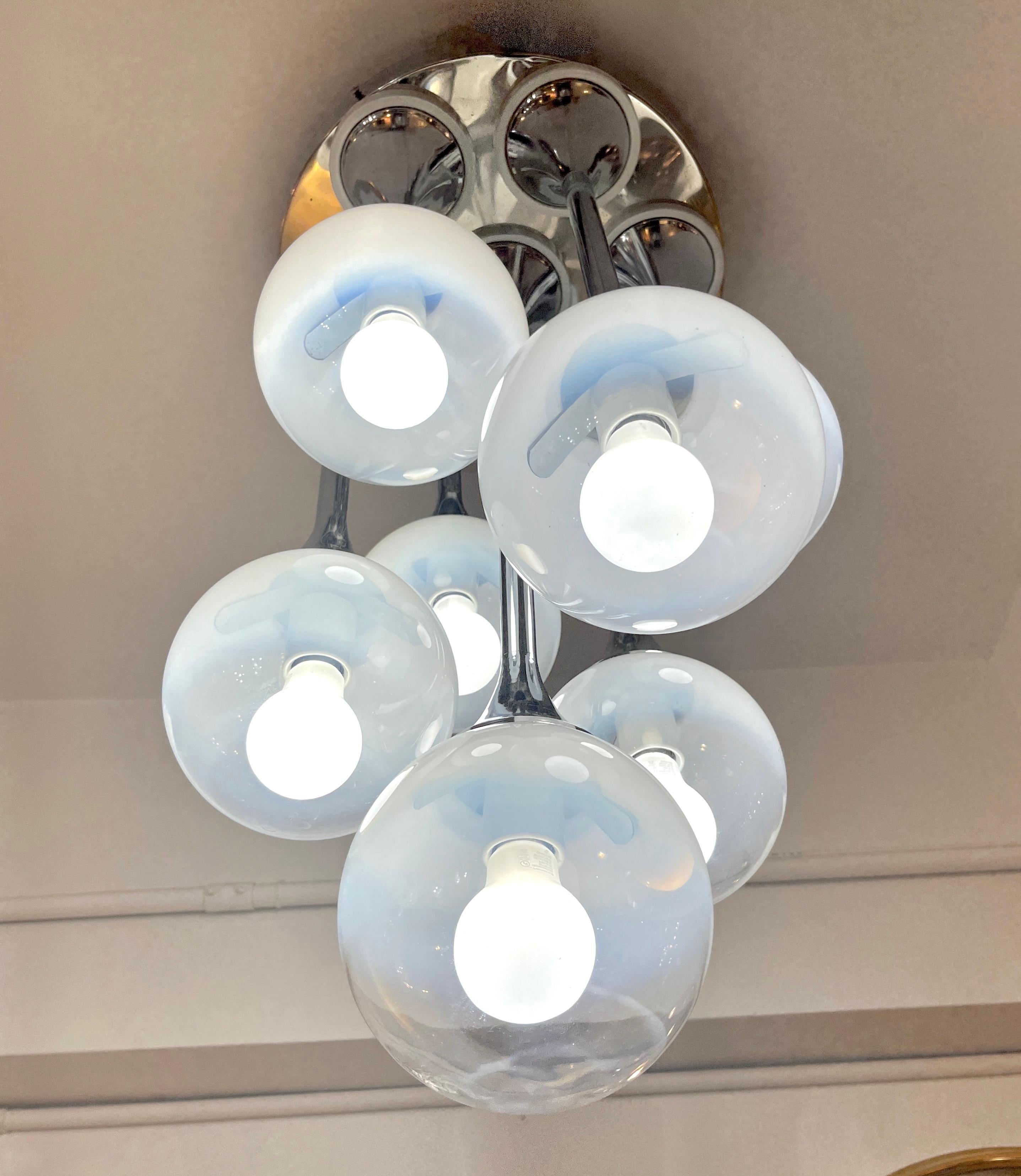 Mid-century modern Italian light fixture by Goffredo Reggiani, a versatile creation that is a flush mount pendant chandelier but can also be used as a table lamp. This piece is highly collectible and interesting because it bears the 7 original round
