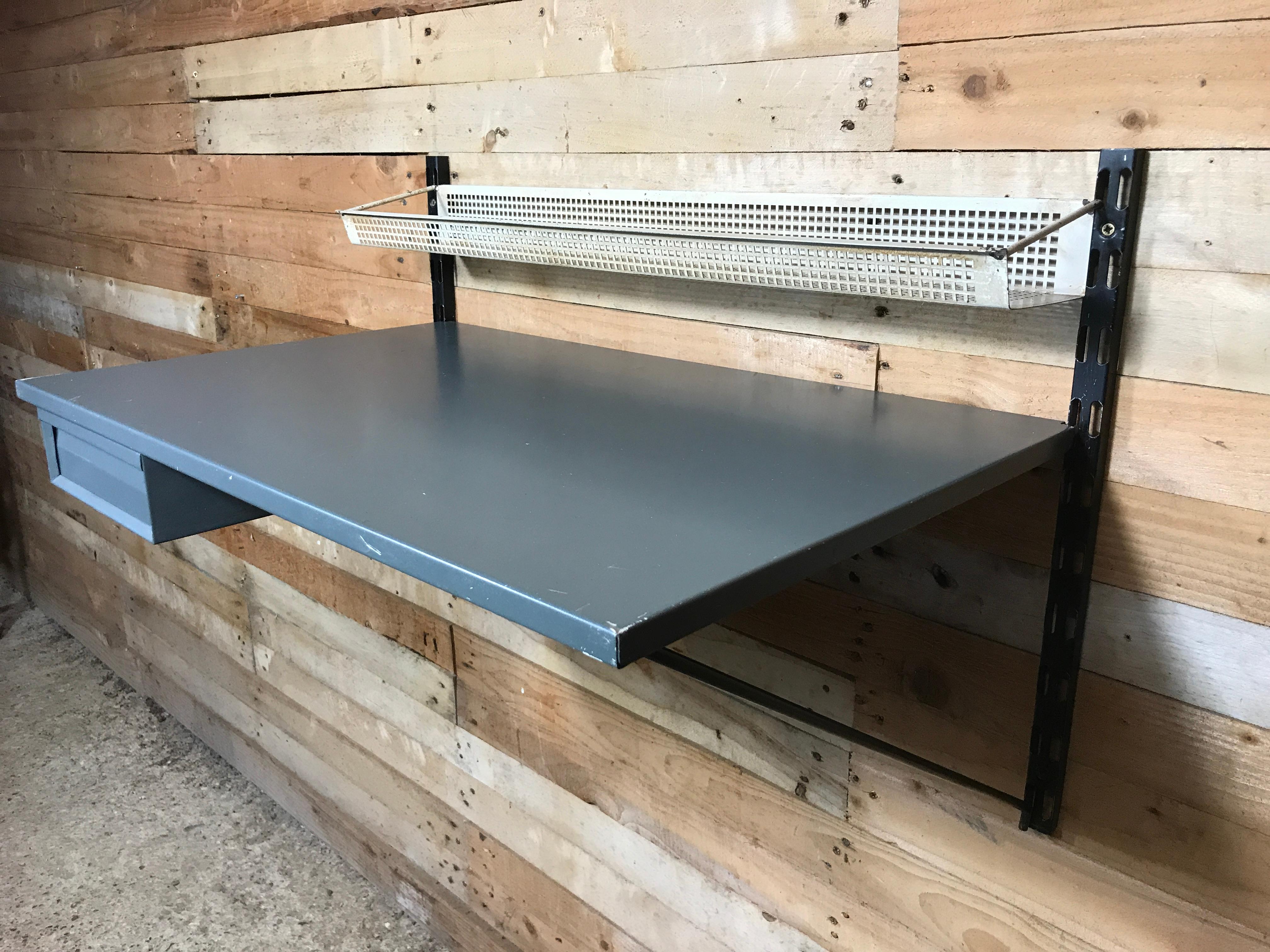 1960 retro Pilastro Tomado shelving grey metal desk unit with drawer and shelf designed by Tjerk Reijenga for Tomado, Holland. The wall unit is in very good vintage condition.

Measures: Height 50cm, depth desk 46cm, width 76cm.