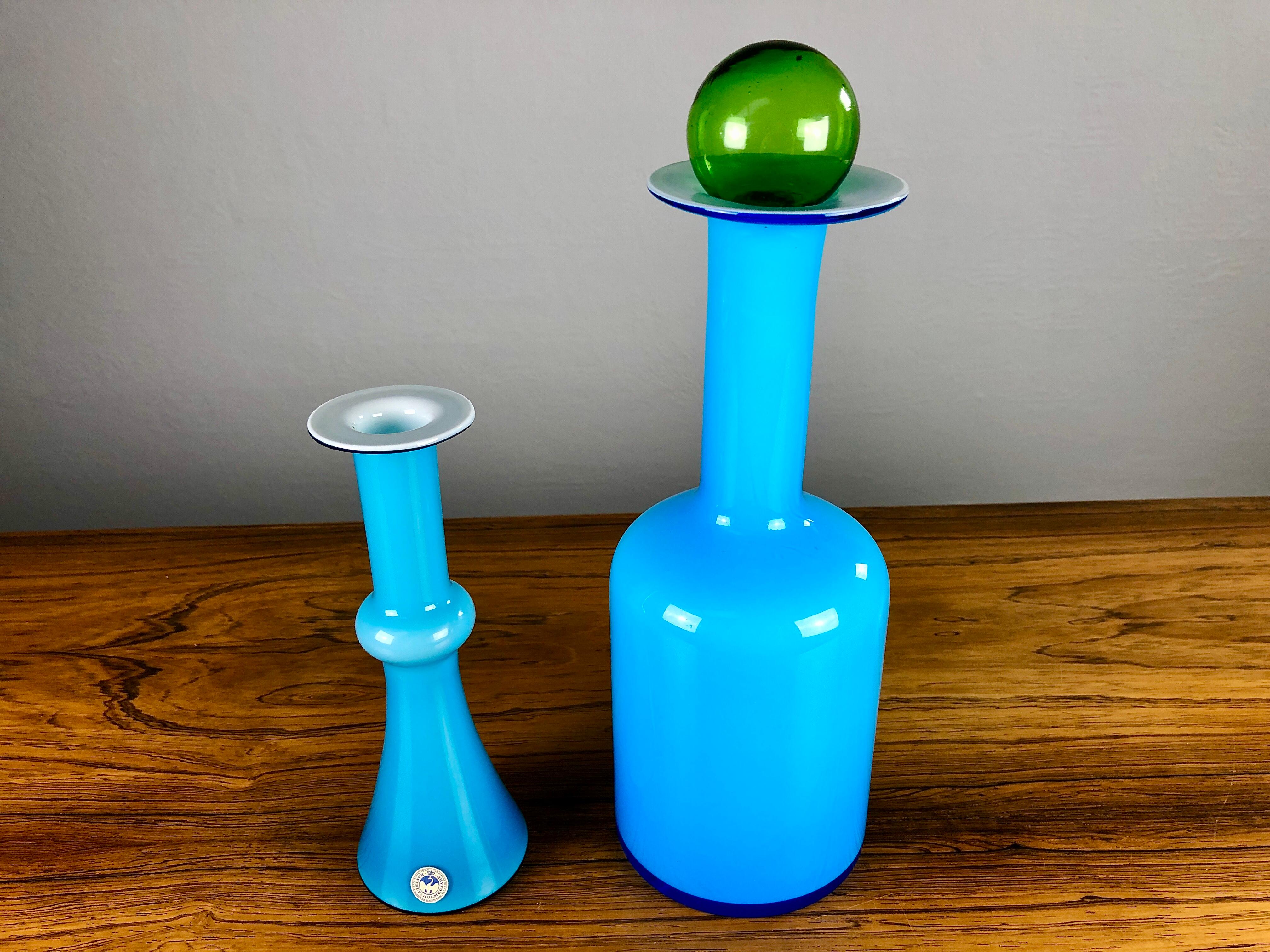 Set of two Danish handblown vases in blue opal glass by Christel, Christer Holmgren and Otto Bauer for Holmegaard.

The vases are made in bright blue hand blown opal 3 layer glass with a white glass base and a green handblown glass plug/ball. The