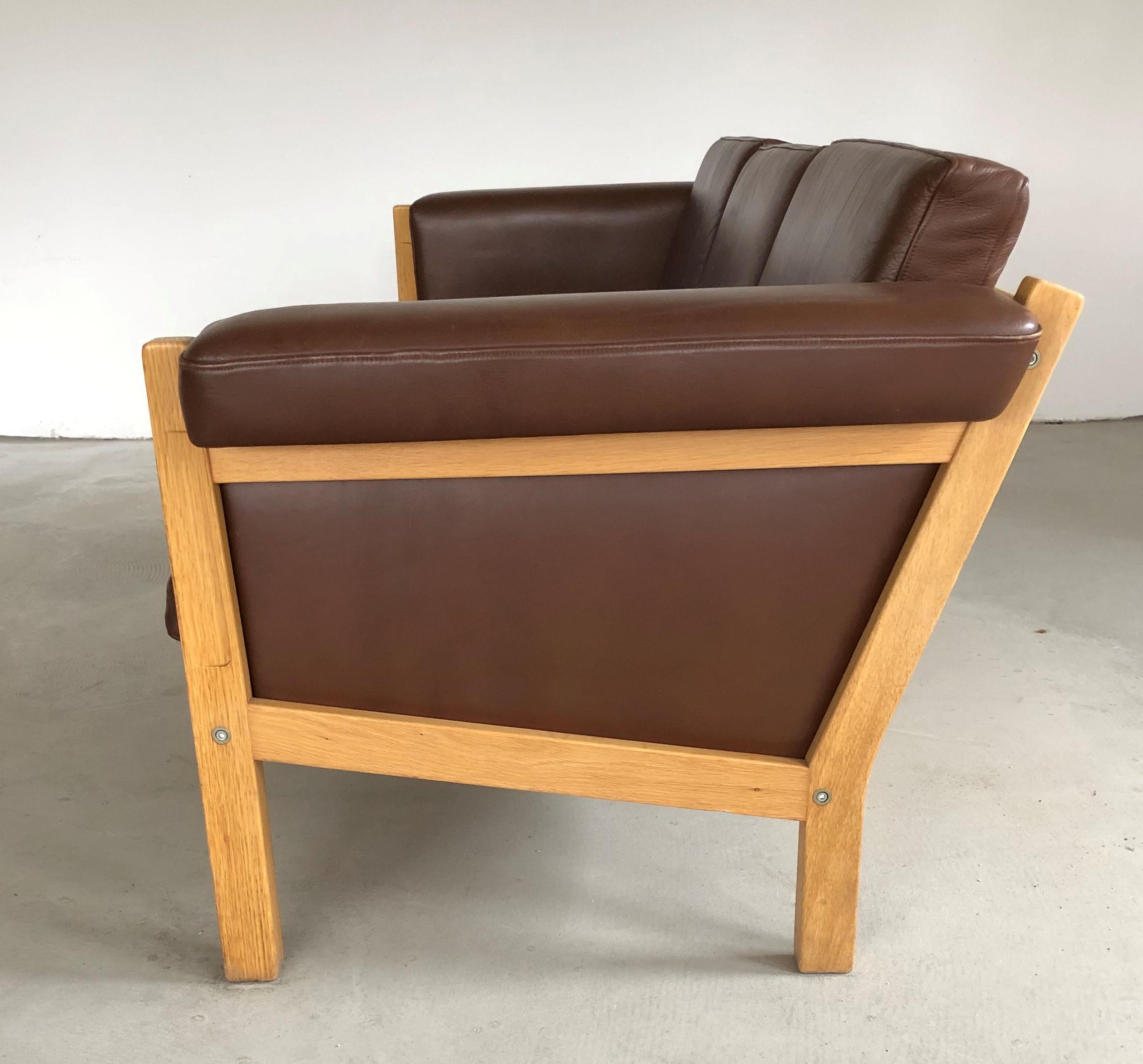 Adam Style 1960s Danish Hans J. Wegner Three-Seat Sofa in Oak and Brown Leather by GETAMA For Sale