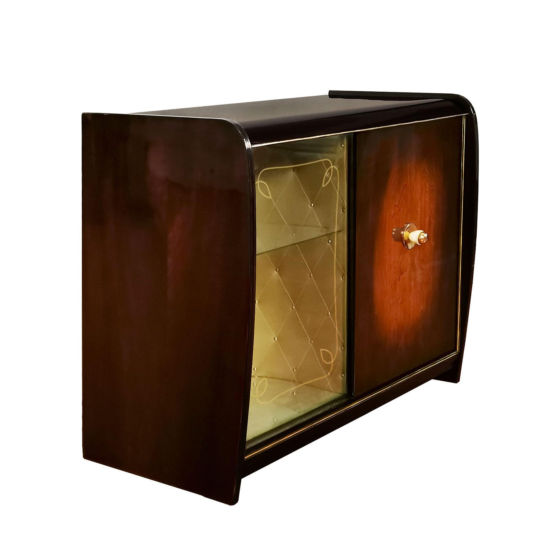 Dry bar with two sliding doors, one in glass with an acid engraved frieze and the other one in walnut with a polished brass handle, French polish. Left interior with the original padded golden green leatherette. Both interiors have a mirror on the