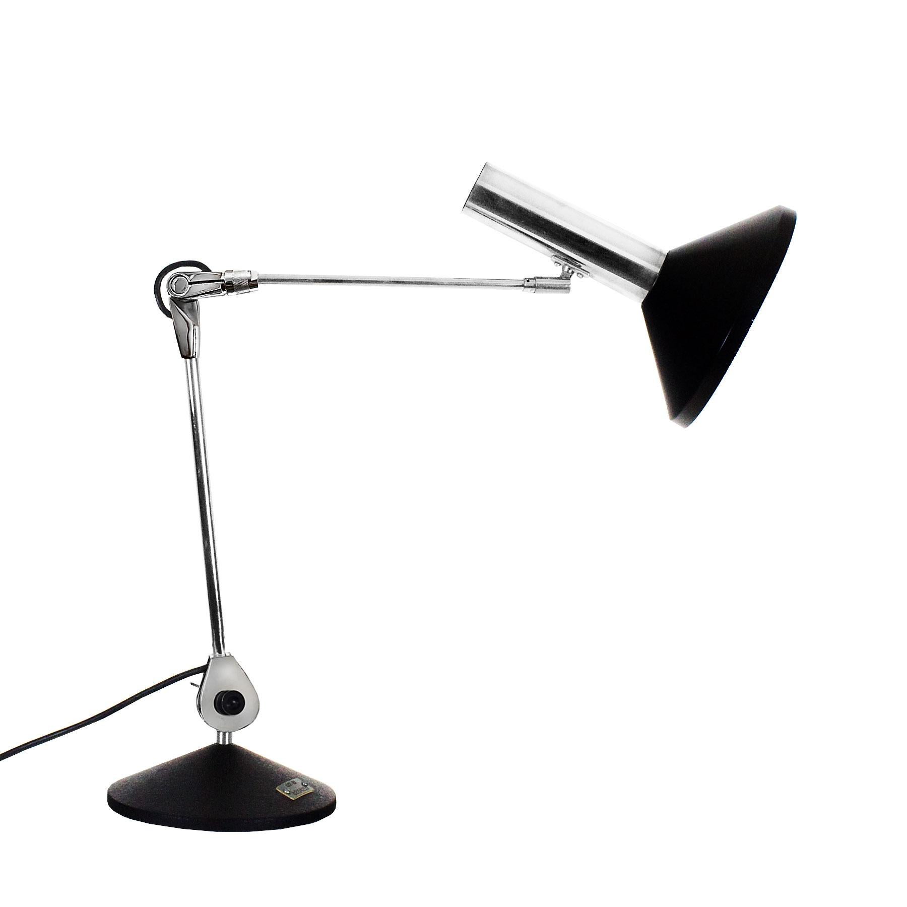 Large articulated chrome-plated desk lamp, granular black painted cast base and black lacquered lampshade. Model used by the C.E.E. (now C.E. European Community).

Belgium, circa 1960

Measures: Max. height 87 cm
Min. height 57 cm.