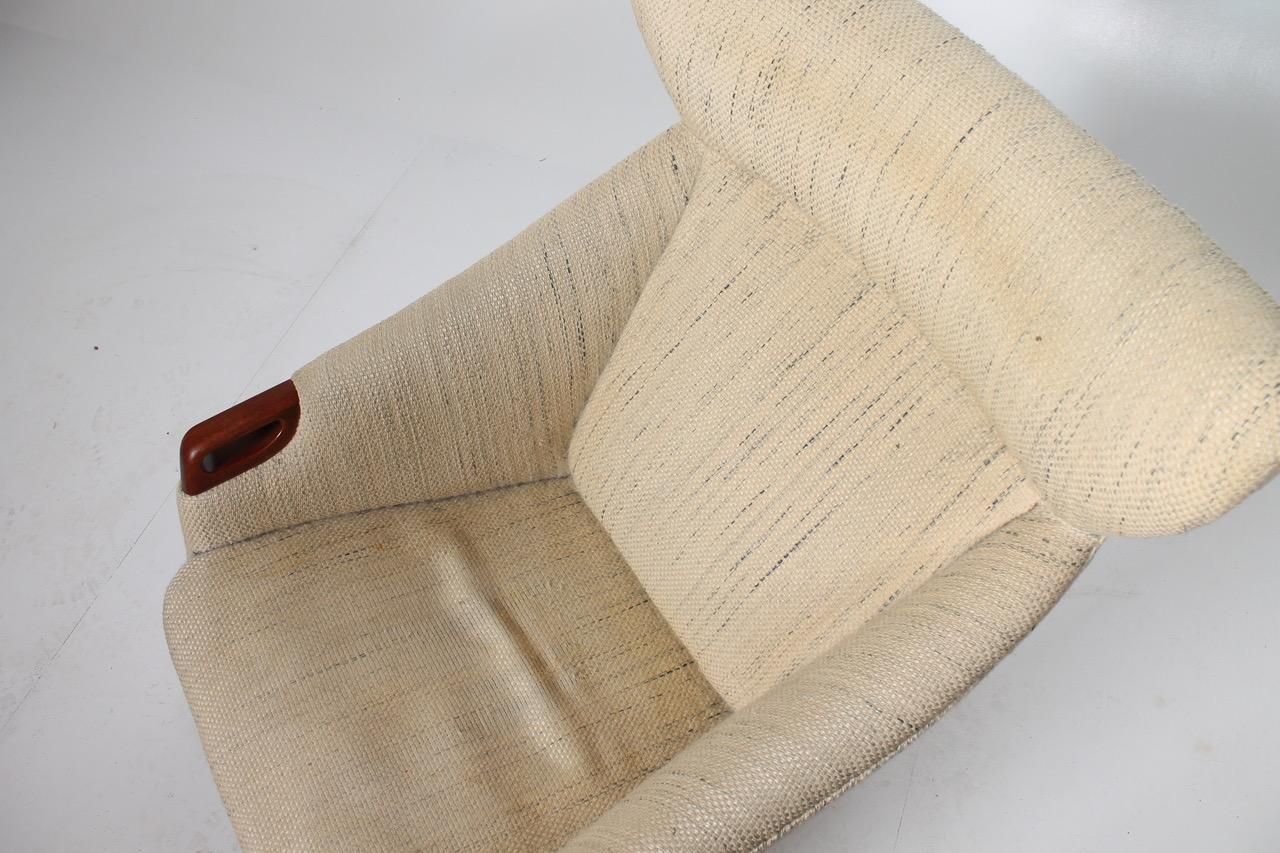 Lounge chair and stool in teak and original fabric. Lots of wear and tear. Designed by Kurt Østervig and manufactured by K.P møbler, Denmark.