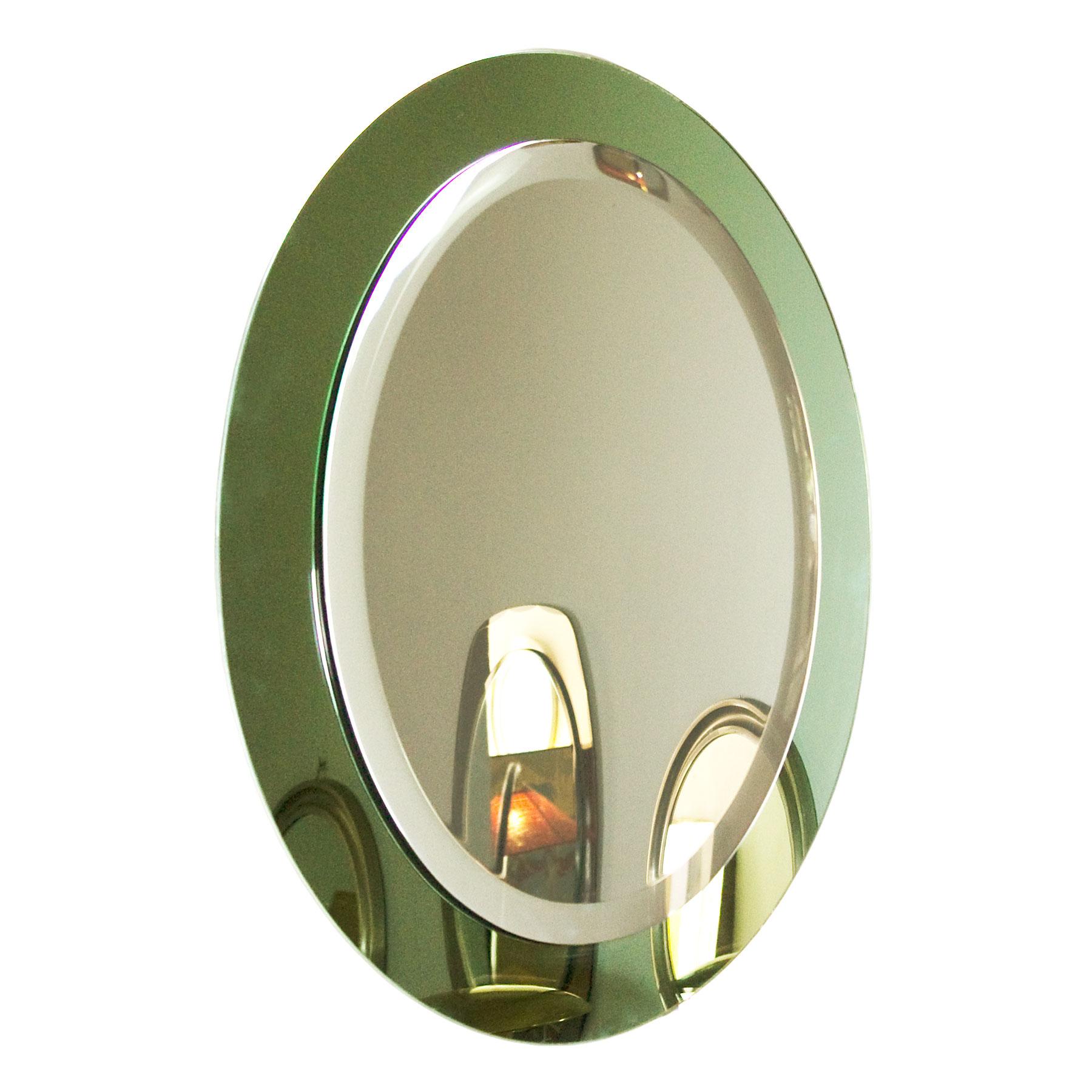 Oval back beveled mirror with light green mirror frame.

Italy, circa 1960.
