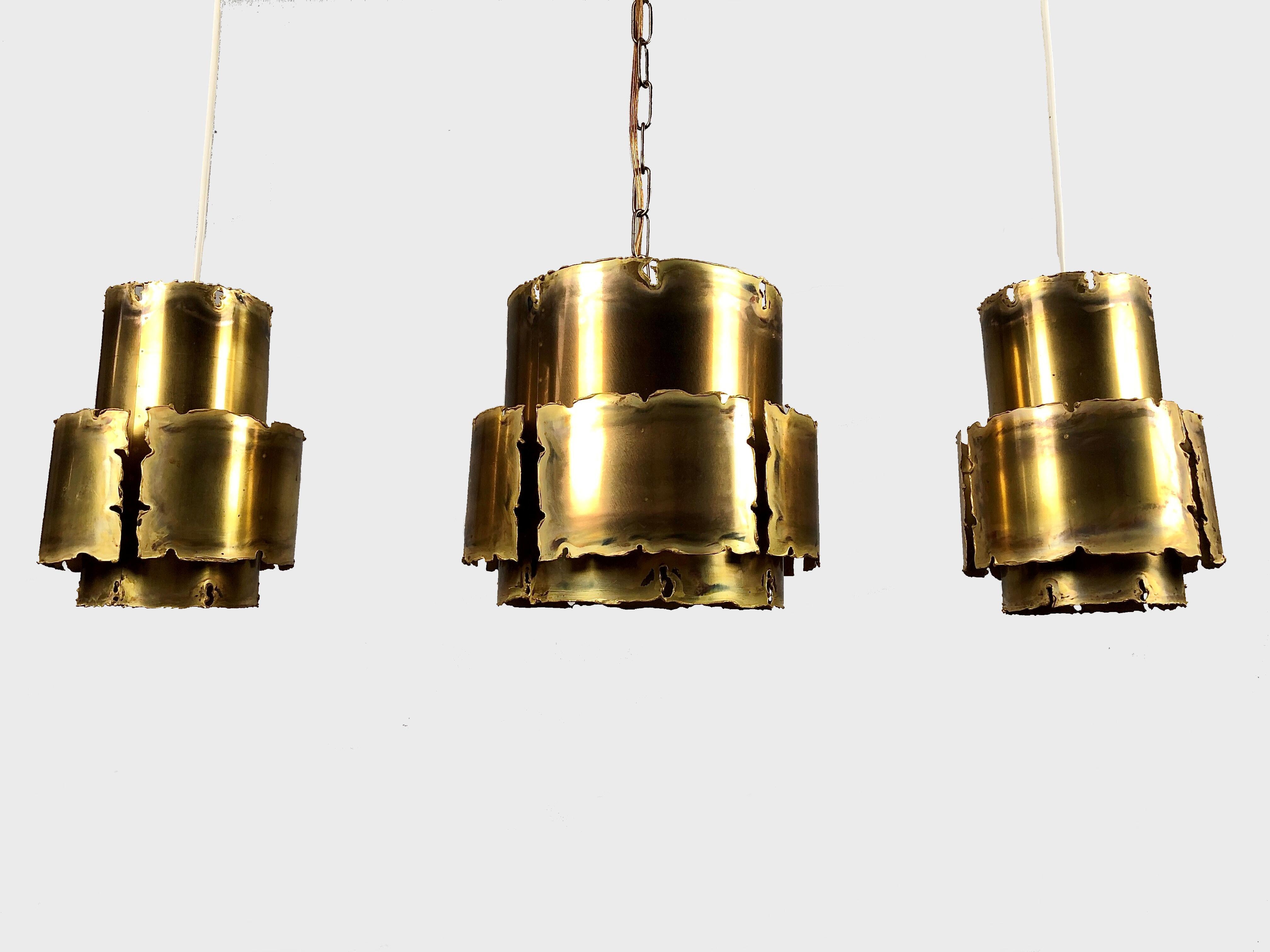 1960´s Set of Three Brutalist style pendants by Svend Aage Holm Sorensen

The acid treated and torch-cut pendants in brass manufactured by Holm Sørensen in Denmark. 

The well keept pendants are in very good vintage condition with only minor signs
