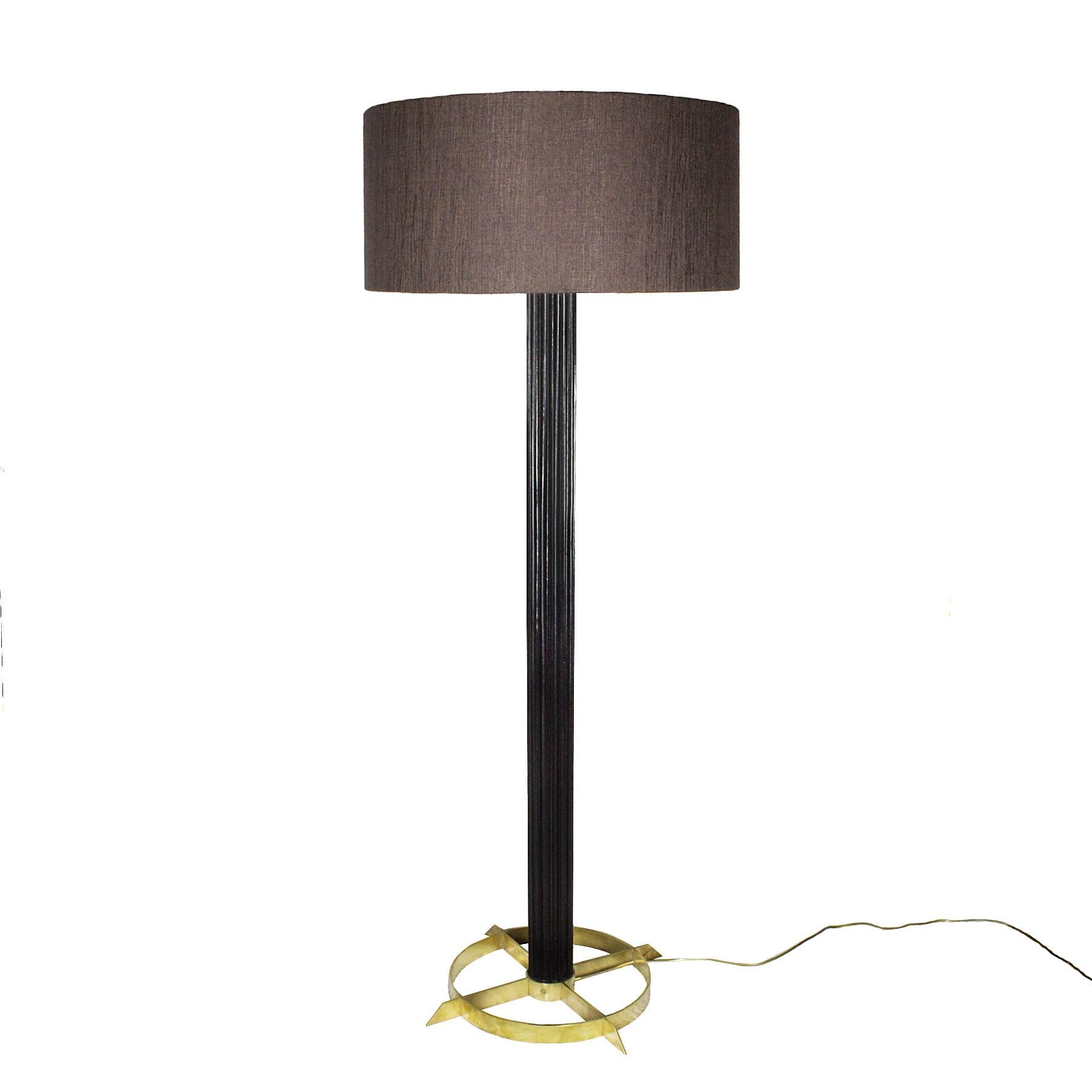 Standing lamp with stained and waxed striated walnut stand and solid brass base. Redone double lightning system. Taupe fabric lampshade.

Design: Jordi Vilanova 

Spain, Barcelona circa 1960.
