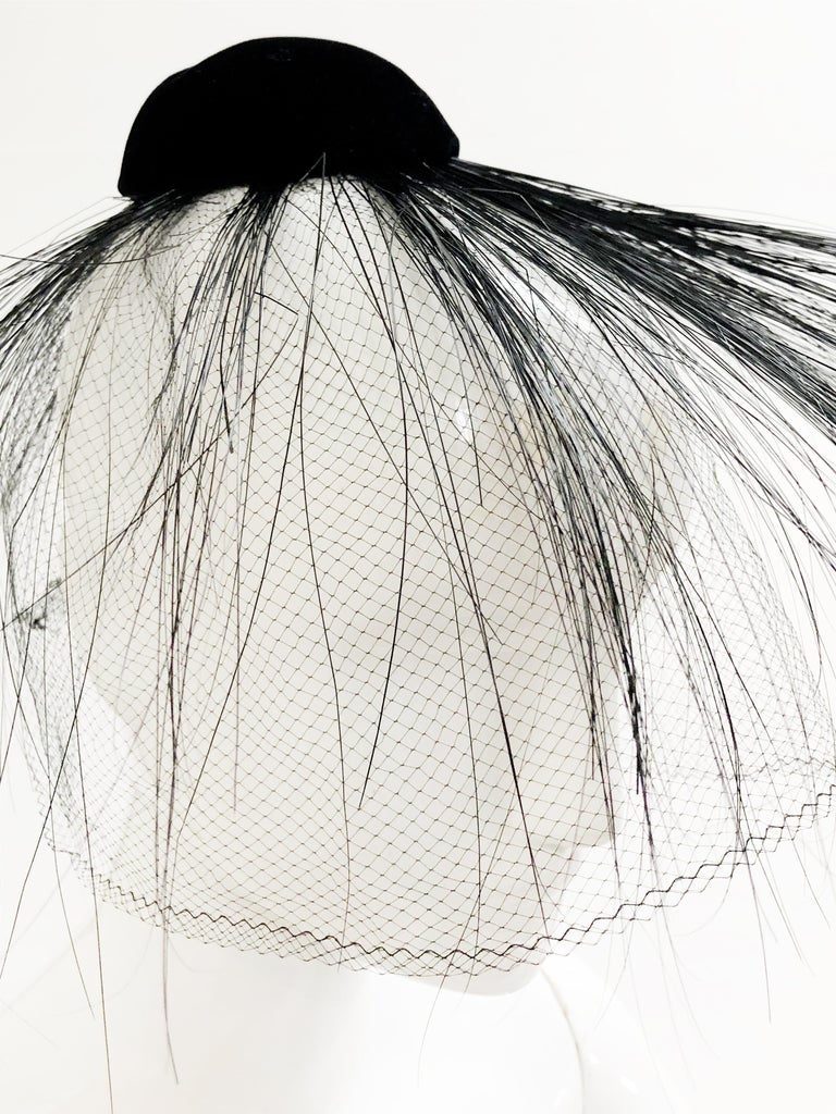 1960s Miss Sally Victor black velvet and singed feather fascinator hat with veil. Cap part of hat is small and meant to perch on head, fastened to hair with the spray of feathers shooting out dramatically in all directions!  One size fits all. 