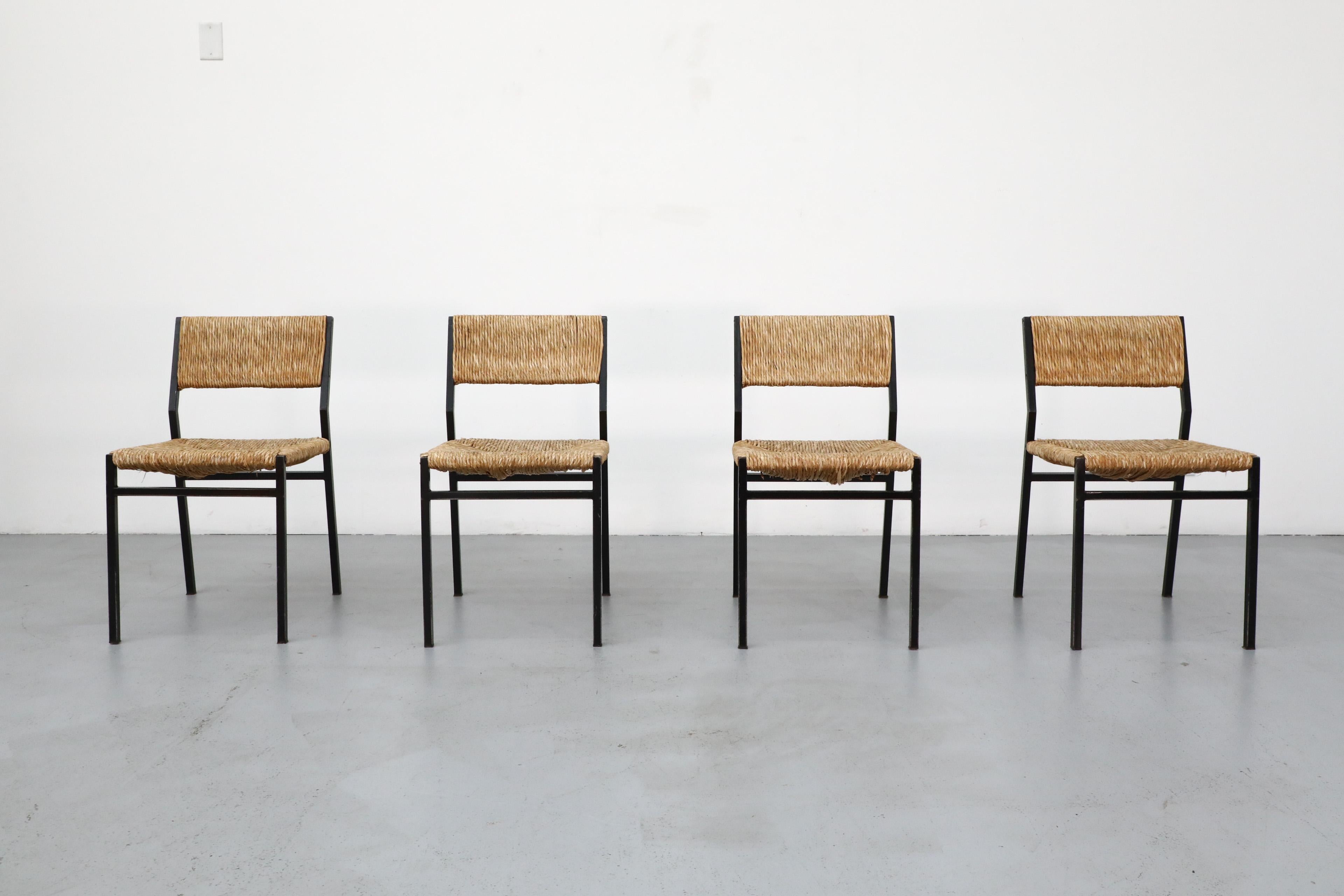 Gorgeous set of 4 dining chairs, created by Martin Visser in 1960 for Dutch furniture manufacturer 't Spectrum. The model features a black metal frame with wicker seat and backrest. All in original condition with visible wear and patina, and signs