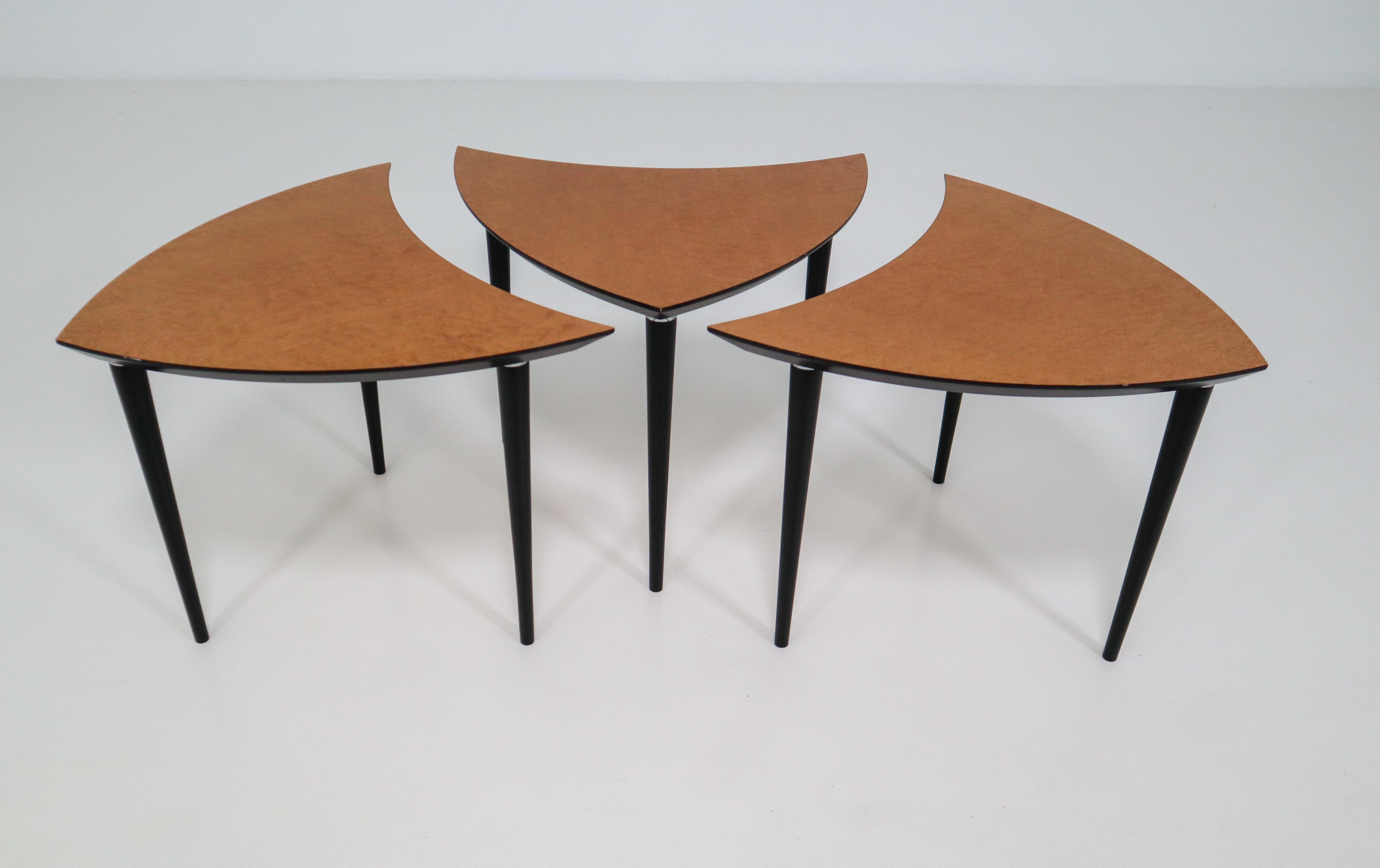 Three triangle-shaped coffee tables from Italy made in 1960. The tables contains a unique shape and elegant legs. The tables fits perfectly into each other. 

The size below stands for one table.