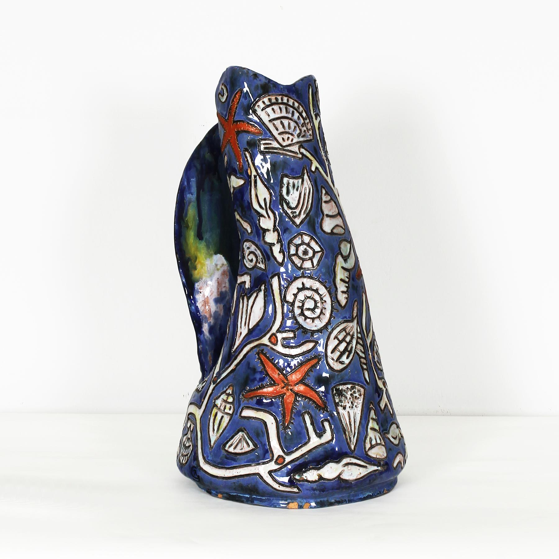 Spectacular enameled ceramic vase, with sea stars and shellfishes decoration, sign at the bottom and base.
Design: Régil (signed)

France, circa 1960.