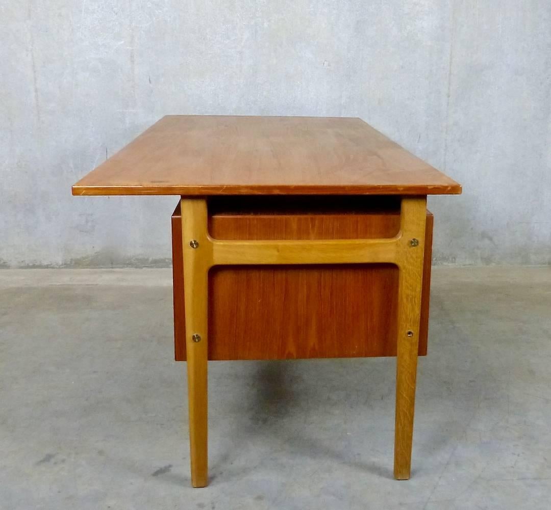 Scandinavian modern teak desk and matching standalone cabinet. Designed in the 1960s by Torben Strandgaard for Mobelfabrik Falster, Denmark. Teak desk is framed with oak legs, has a privacy screen, and features both drawers and filing space.