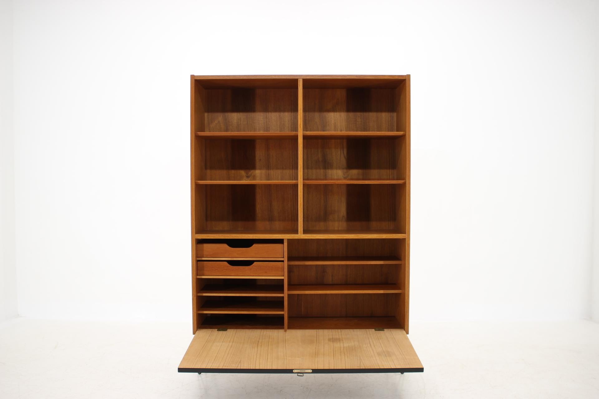 This bookcase was carefully restored. 
The hairpin iron legs were added afterwards. 
All shelves are adjustable. 
The black door was lacquered afterwards.