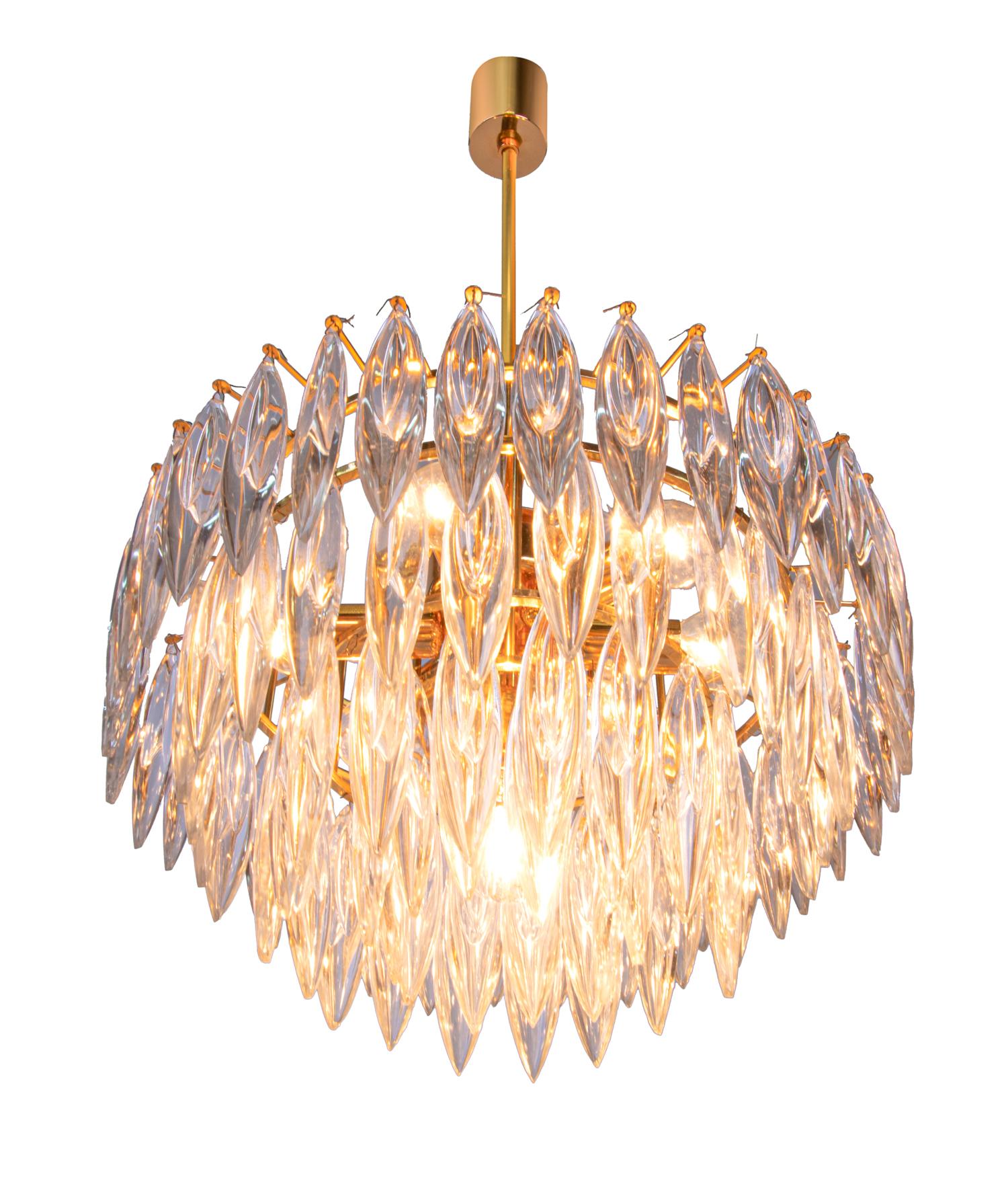 Impressive 7 lights chandelier of excellent quality with long crystals on a gold plated frame. The chandelier has an incomparable unique character through its gold base and the long clear crystals. Manufactured by Lobmeyr / Bakalowits & Sons in