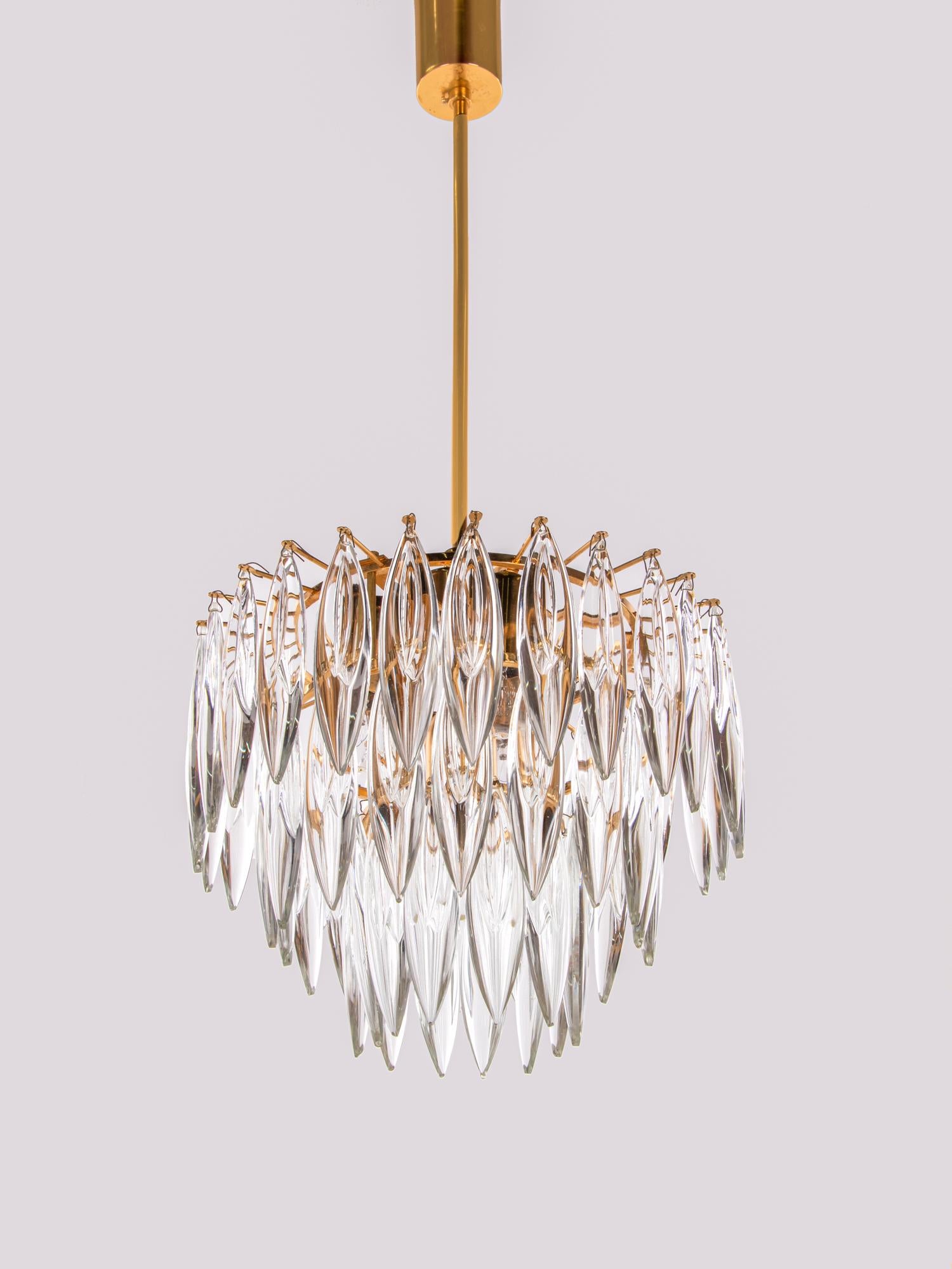 Very impressive 4 lights chandelier of excellent quality with long crystals on a gold plated frame. Manufactured by Lobmeyr / Bakalowits & Sons in Vienna, Austria in the 1960s. 

The lamp has an incomparable unique character through its gold base