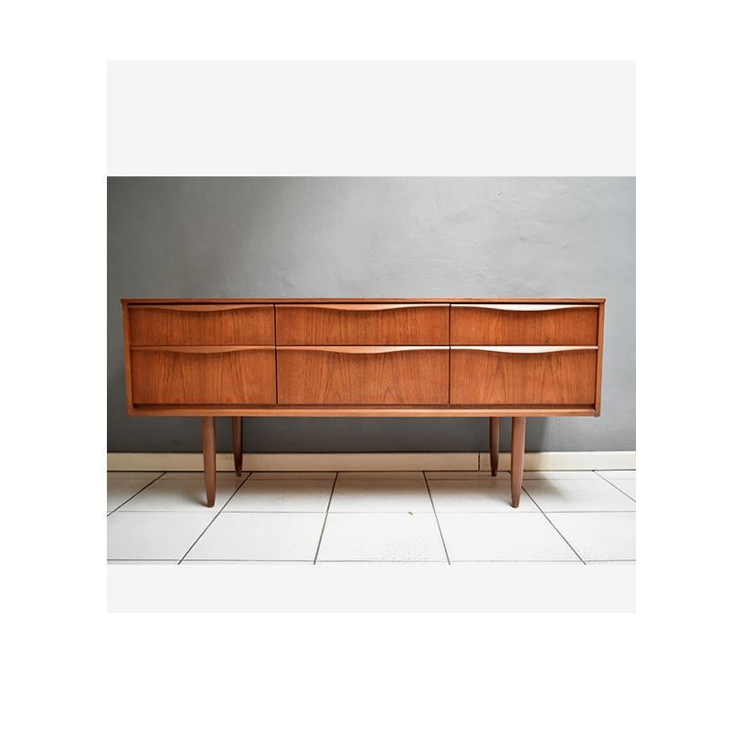 1960, vintage English sideboard - chest of drawers in teak 
Design by Frank Guille for Austinsuite.
The teak chest of drawers has six storage drawers.
On the back you can see the production label.