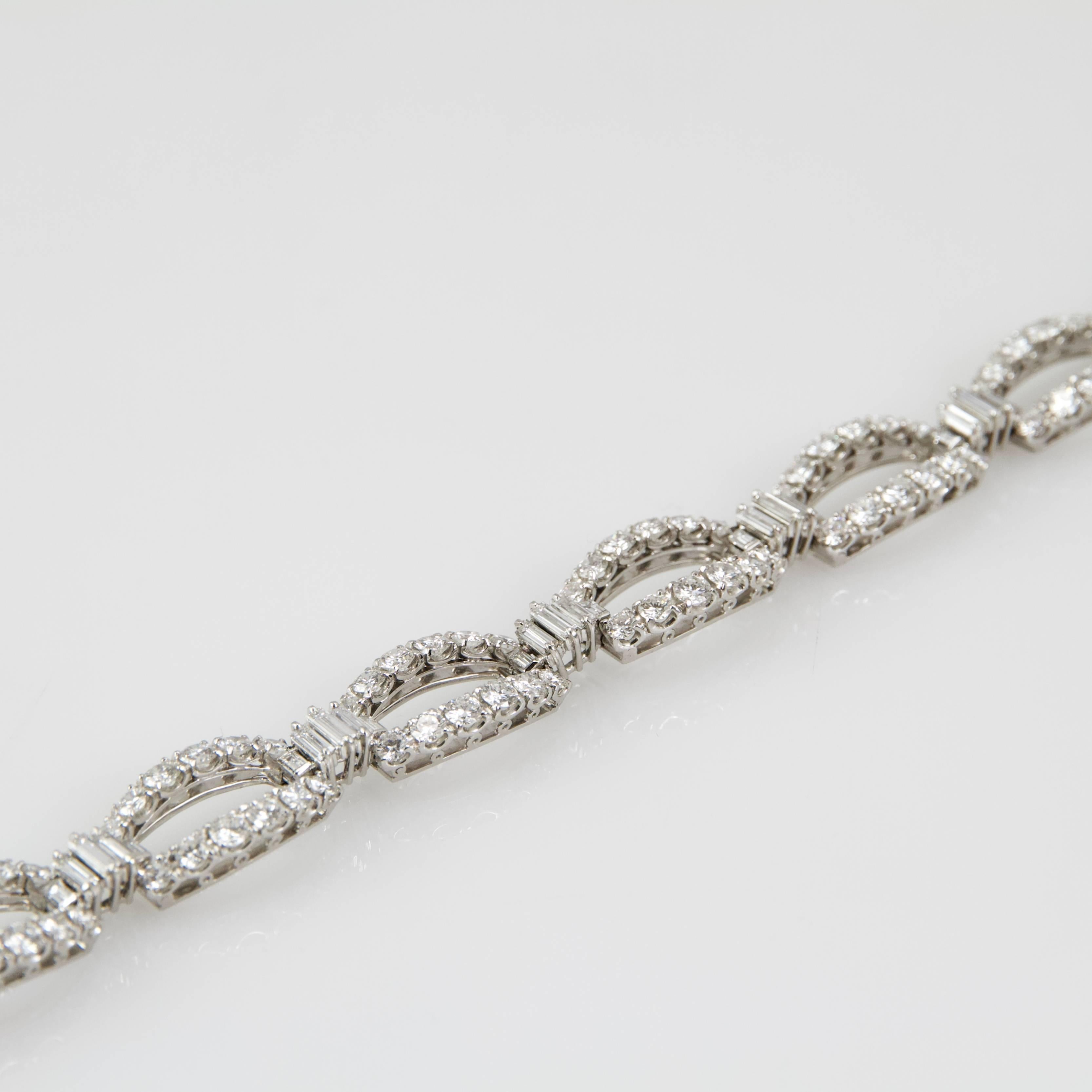 White gold and diamonds bracelet composed by seven bevelled oval links ( lucky number) and set with rounds and baguette shape diamonds. 
Total weight of diamonds: 12 to 15 carats. 
Very good quality in color and clarity ( H and VS)
Safety system.