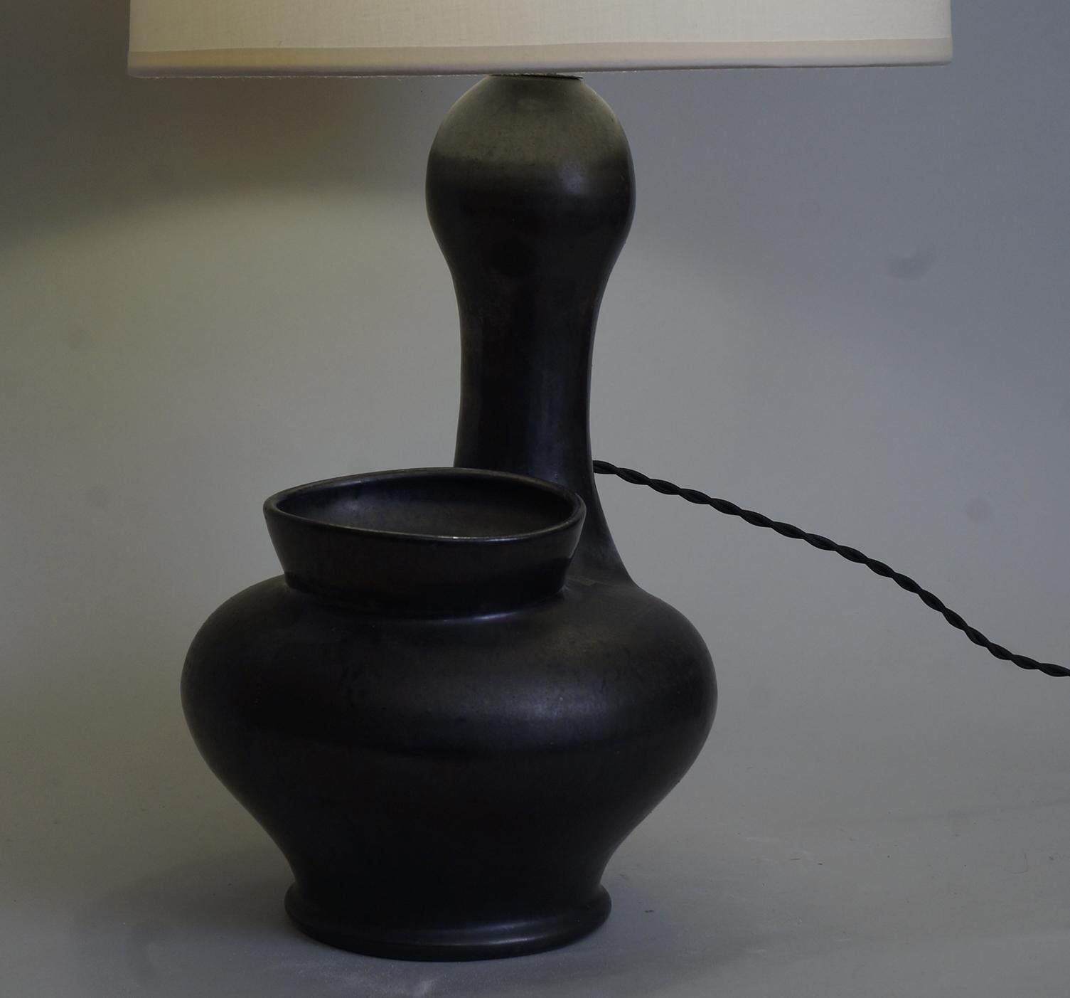 Zoomorphic black satin ceramic table lamps, custom-made fabric lampshade, rewired with twisted silk cord.

Measures: Ceramic body height 31 cm / 12.2in.
Height with lampshade: 54 cm / 21.3 in.
