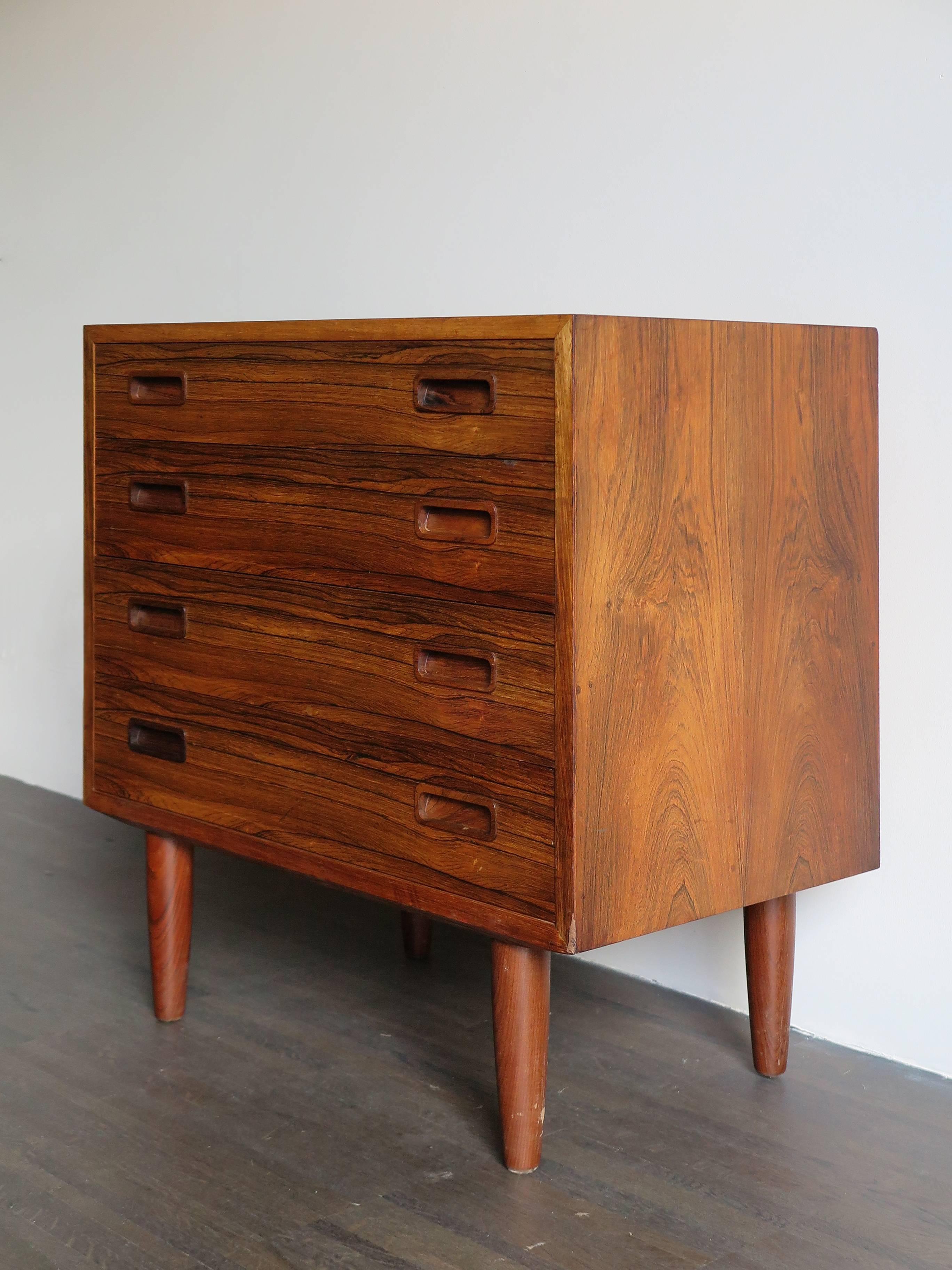 Little Danish Scandinavian Modern rosewood chest of drawers with four drawers with turned wood handles, midcentury design, circa 1960.