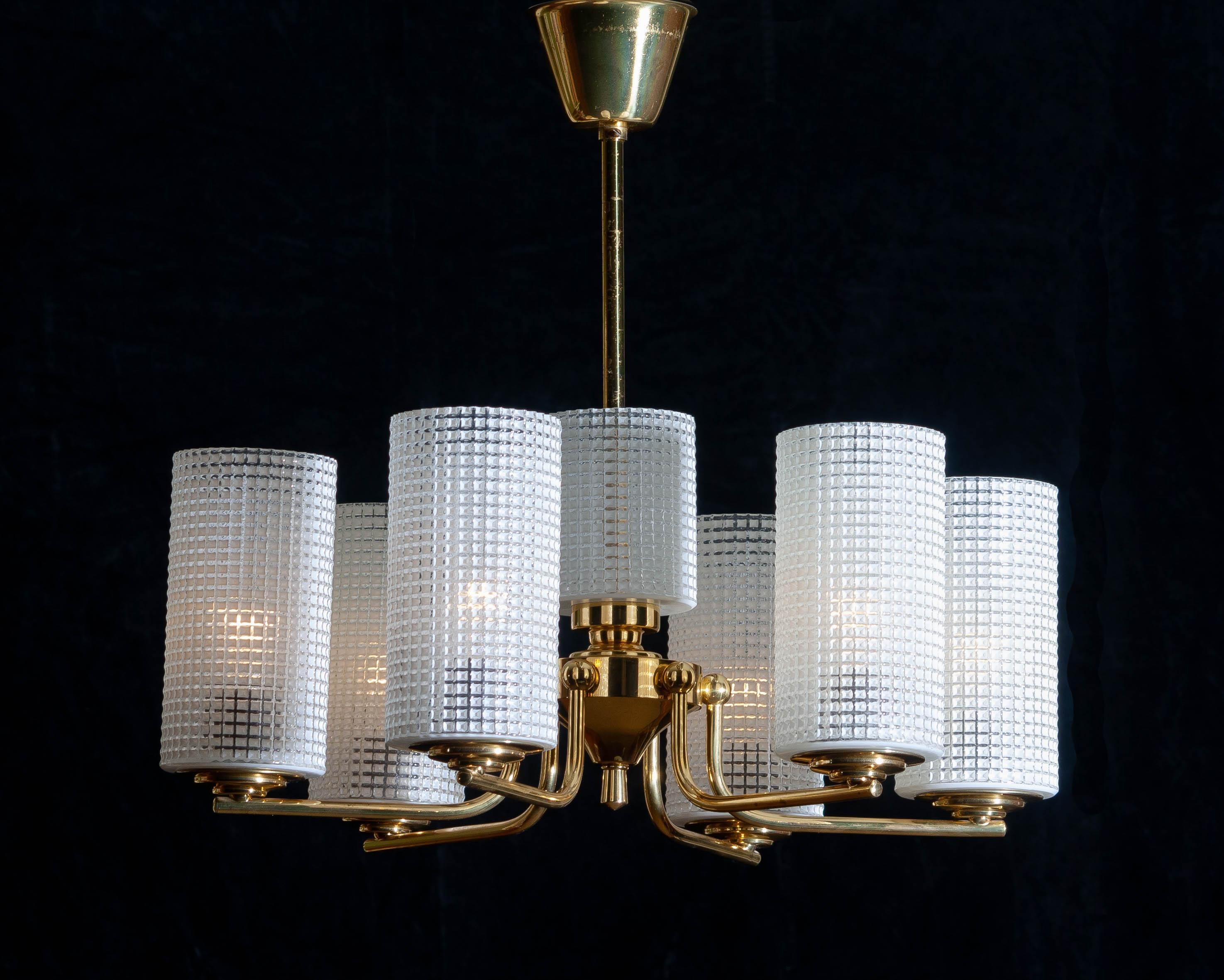 1960s. Beautiful and excellent brass chandelier designed by Carl Fagerlund for Orrefors, Sweden.
The six glass vases are 18cm / 7 inch high. The one in the middle is 11cm / 4.3 inch.
The overall condition is very good.
   