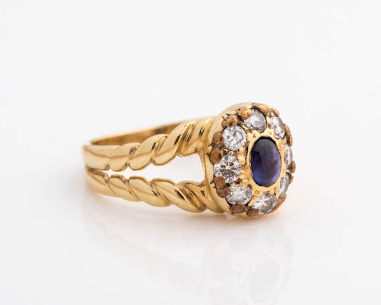 1960s Retro Sapphire, Diamond Halo Ring - 18k Yellow Gold, Sapphire, Diamonds

Features an oval Blue Sapphire center stone with a Diamond Halo. The split shank ring has twisted rope gold band shoulders. The gold rope bands flow into a smooth shank.
