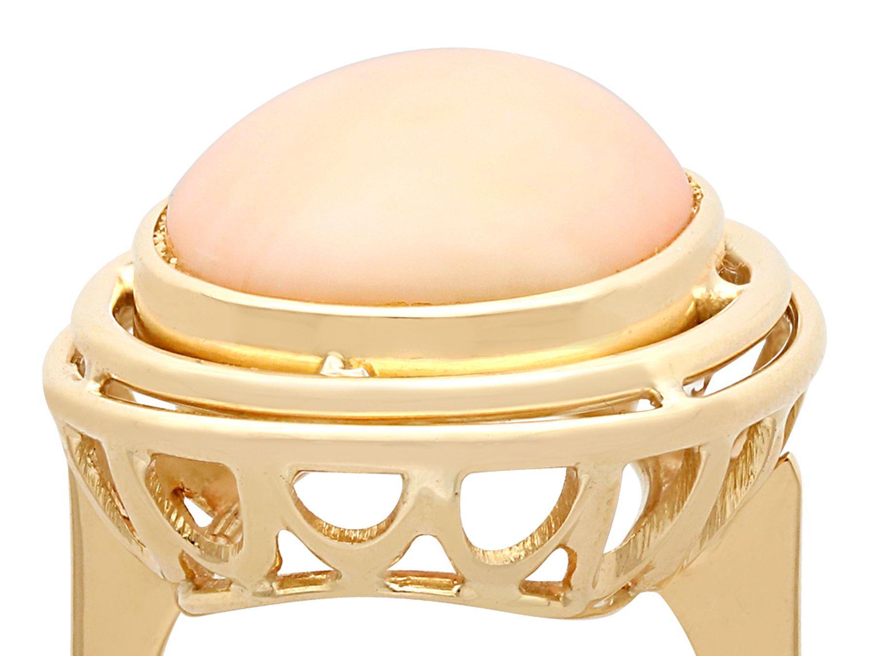 A stunning, fine and impressive vintage 13.98 carat coral and 14 karat yellow gold cocktail ring; part of our diverse vintage jewelry and estate jewelry collections.

This stunning, fine and impressive cabochon cut coral vintage ring has been