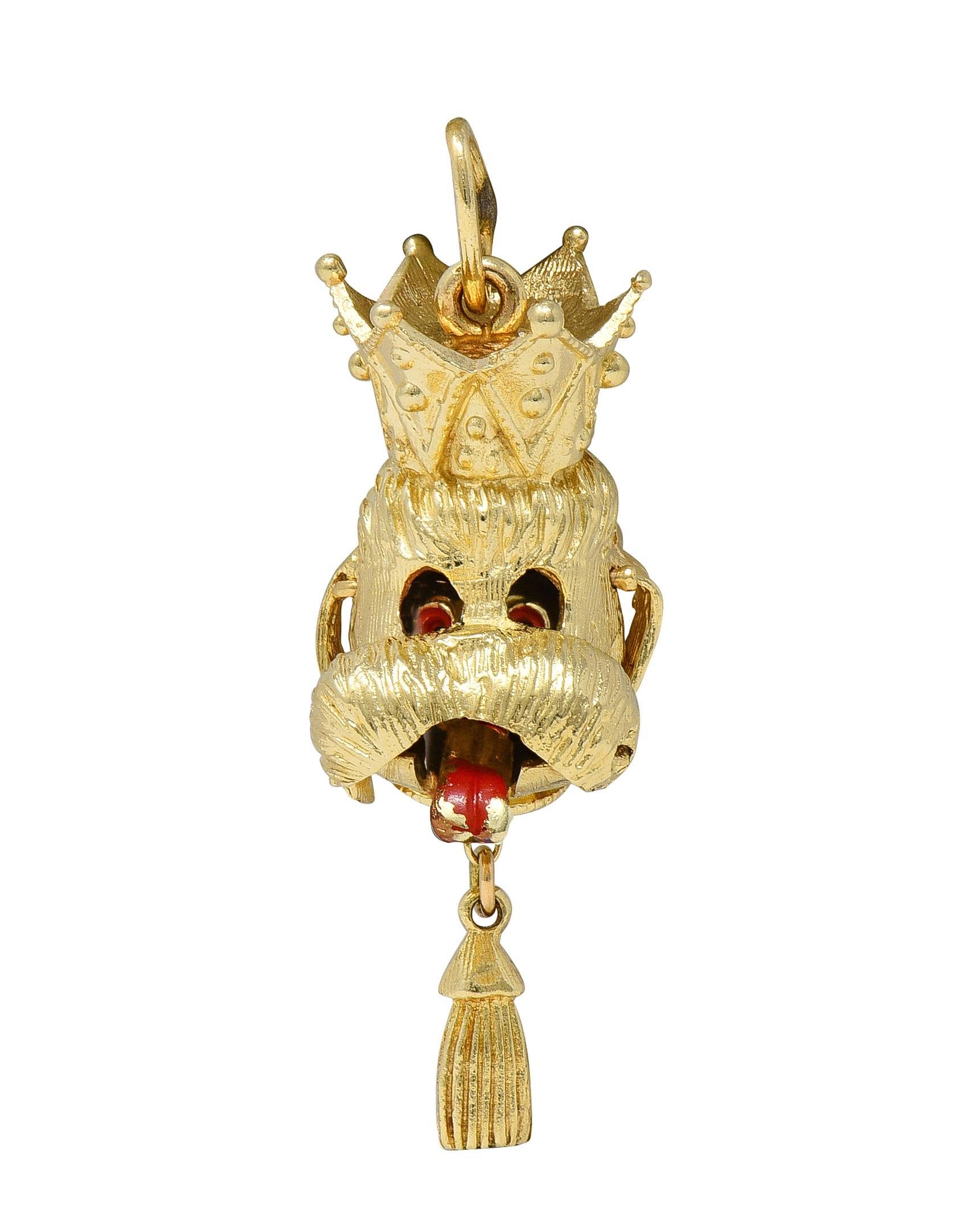 Designed as a highly dimensional dog head wearing a crown and suspending a tassel
Eyes droop and tongue sticks out if tassel is pulled - both glossed with enamel
Opaque red in color and displaying loss consistent with age
Engraved with linear fur